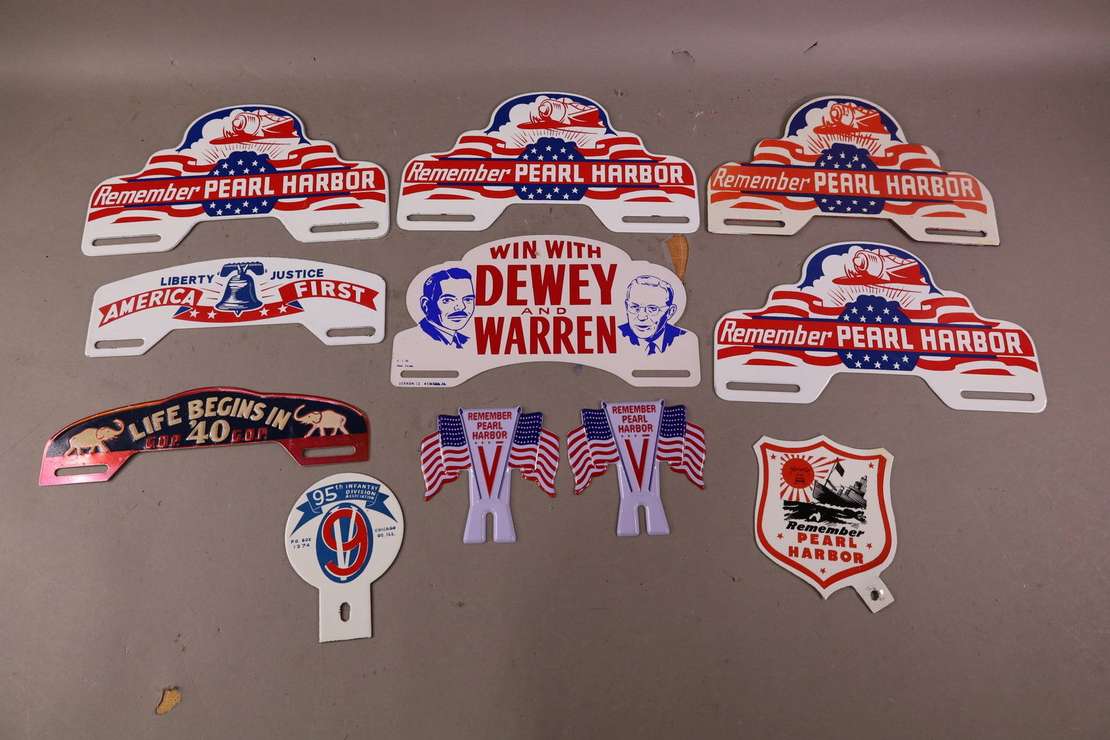 GROUPING OF LICENSE PLATE TOPPERS: REPRODUCTION POLITICAL & PEARL HARBOR PORCELAIN AND TIN.