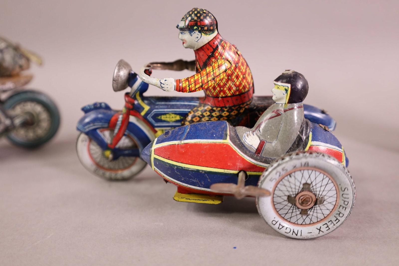 4 TIN LITHO MOTORCYCLES - 4