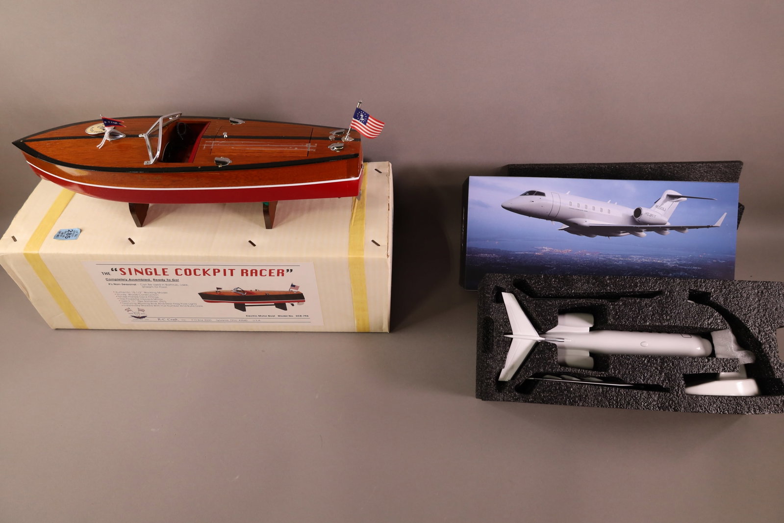 2 SCALE MODELS: RC CRAFT SINGLE COCKPIT RACER BOAT IN BOX. & XOJET AIRPLANE IN BOX.