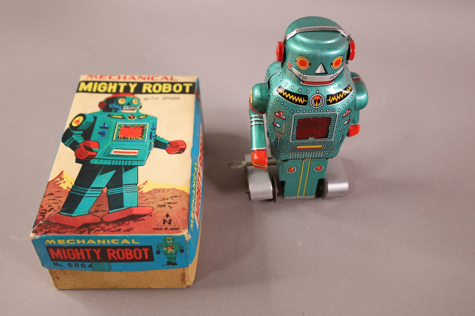 JAPANESE MECHANICAL MIGHTY ROBOT: IN ORIGINAL BOX, JAPANESE WIND UP MECHANICAL MIGHTY ROBOT. 5 1/2"