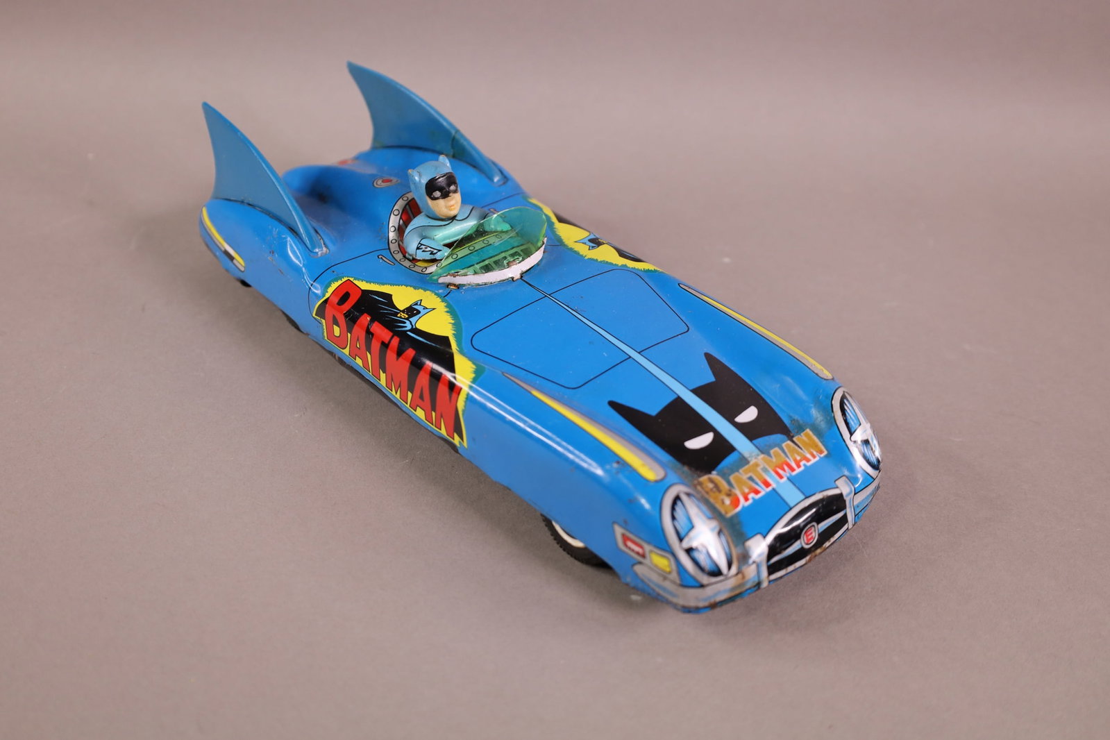 JAPANESE FRICTION BATMAN CAR: RUST AND STAINING. REPAIR TO FIN. 11" L