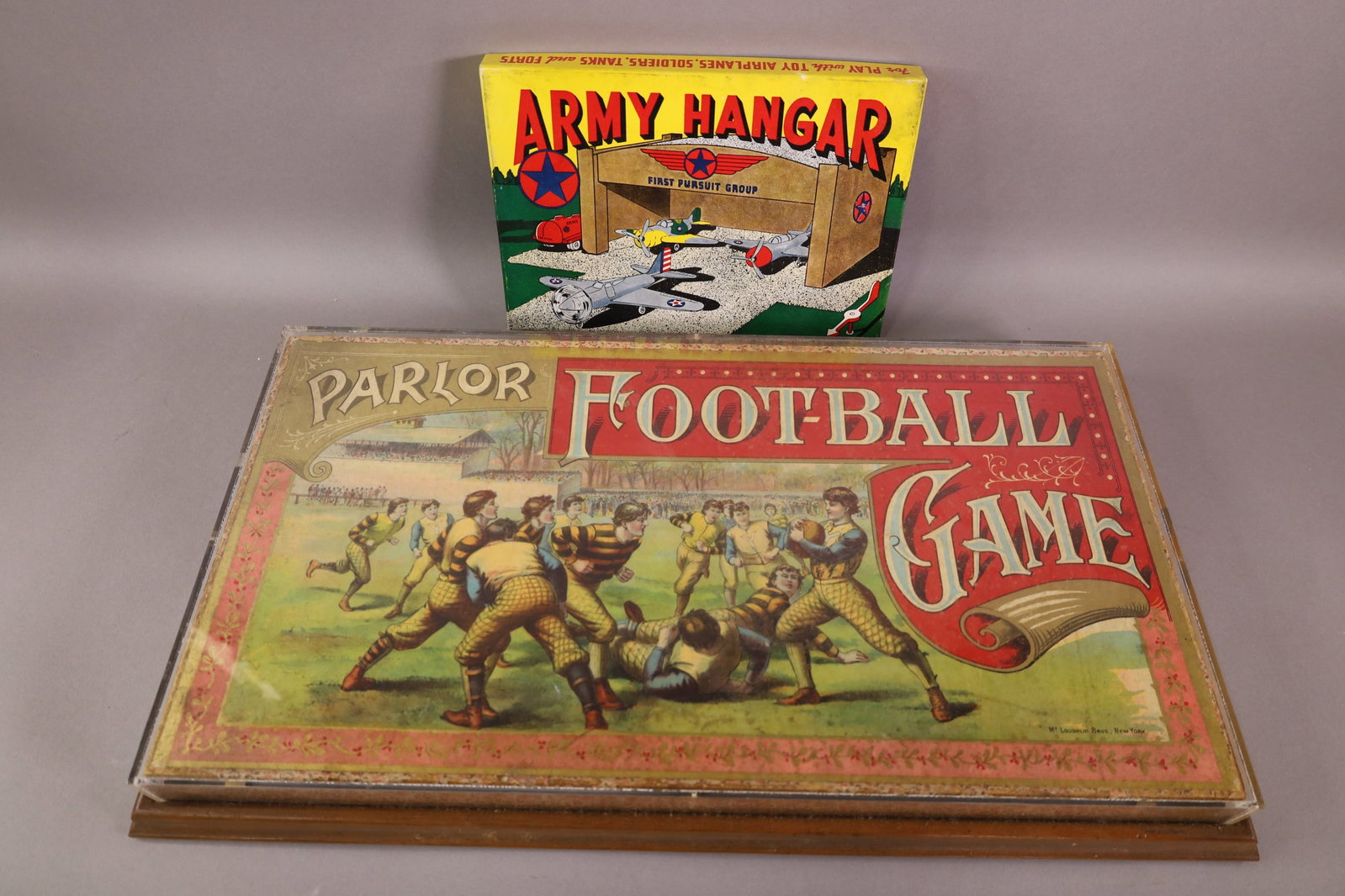2 ANTIQUE PAPER TOYS: FOOTBALL GAME IN FRAME (UNKNOWN CONTENTS) & ARMY HANGAR IN ORIGINAL BOX 10 - 20" W