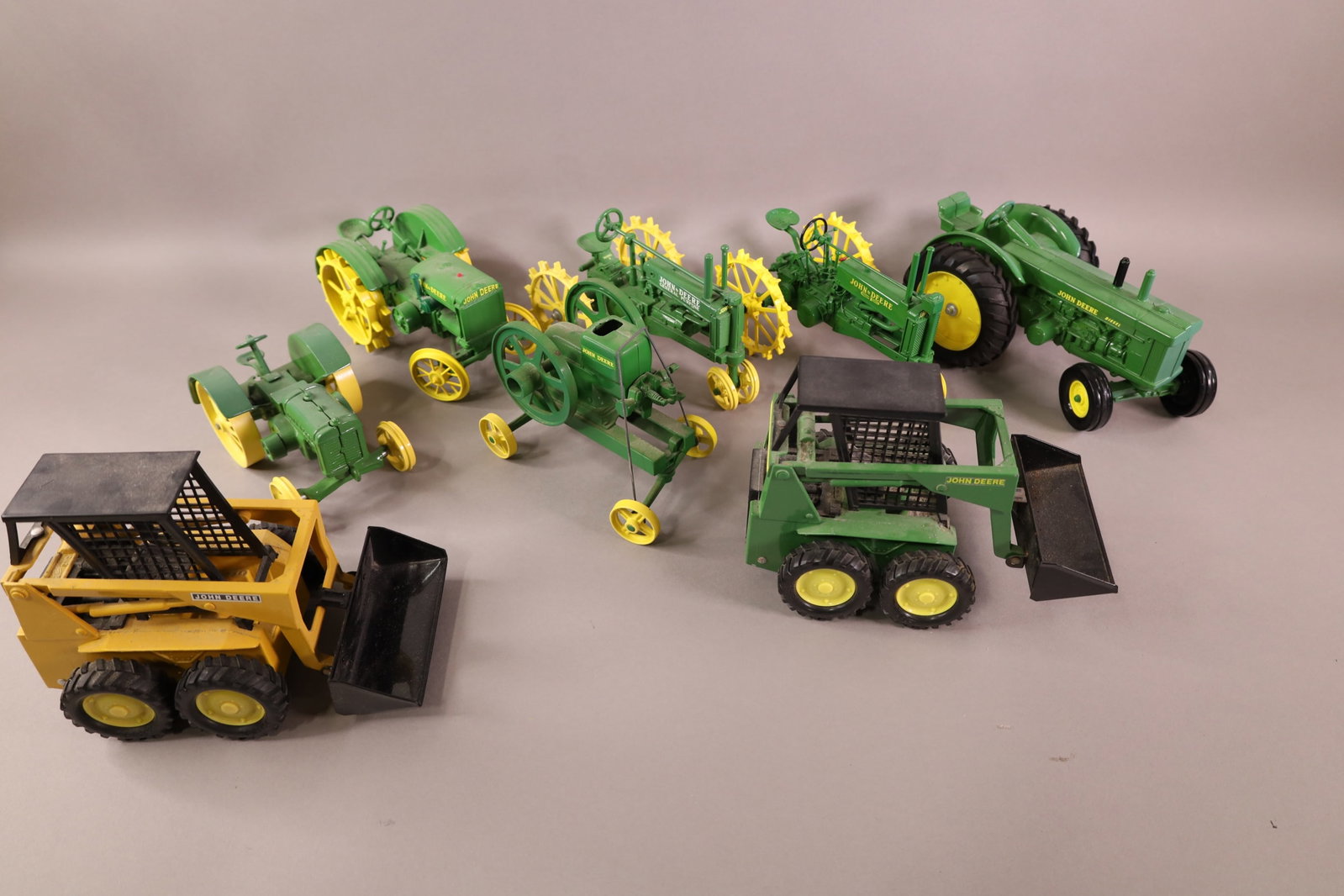8 JOHN DEERE TOYS: 6 TRACTORS & 2 BOBCATS. ALL ERTL. 6" - 9" L