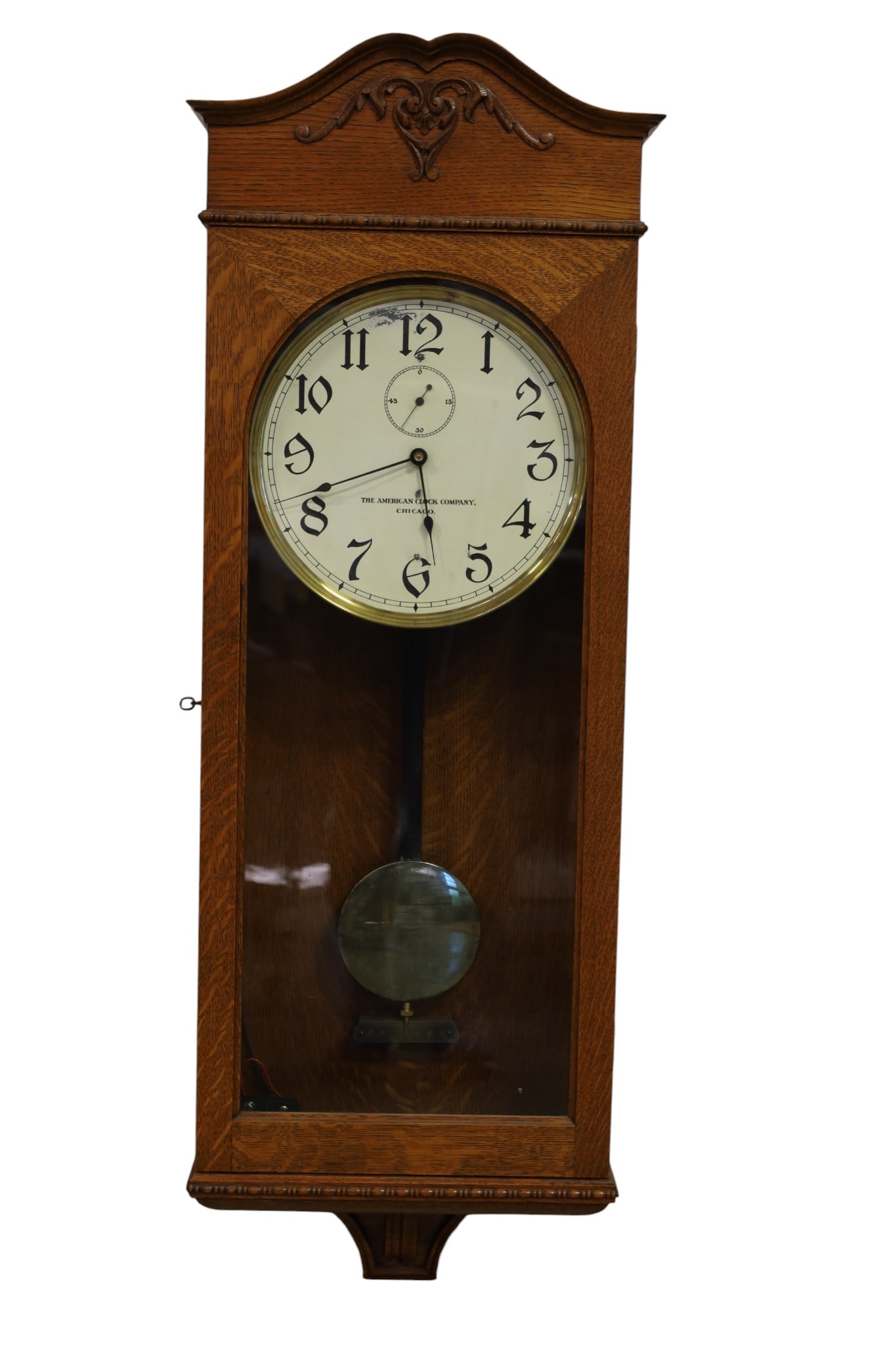 AMERICAN CLOCK CO WALL CLOCK: SELF WINDING WALL CLOCK, AMERICAN CLOCK CO, OF CHICAGO. OAK CASED. 48" H. ALL CLOCKS ARE SOLD AS IS WE DO NOT GUARANTEE WORKING ORDER. THIS ITEM EXCEEDS SIZE, WEIGHT, AND OR FRAGILITY LIMITATIONS FOR 