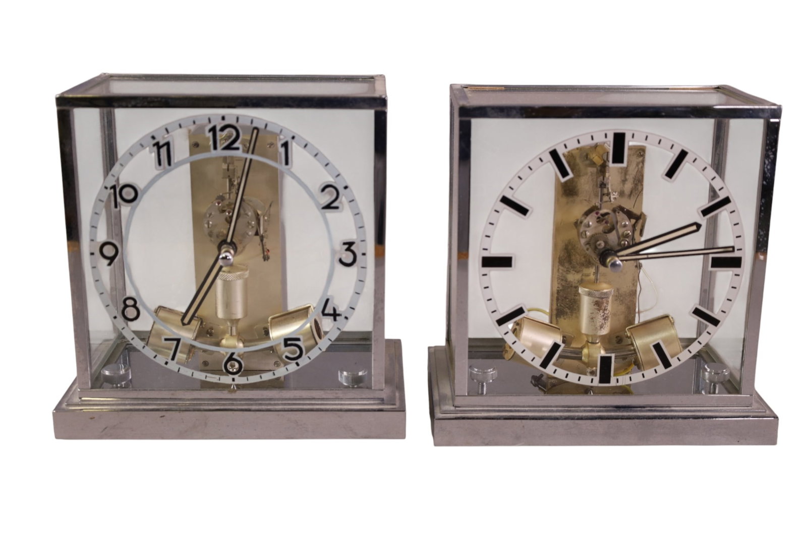 2 JUNGHANS MANTLE CLOCKS: MAGNETIC PENDULUM CLOCK, IN GLASS CASE, WITH CHROME FRAME. 8 1/2" H. ALL CLOCKS ARE SOLD AS IS WE DO NOT GUARANTEE WORKING ORDER.