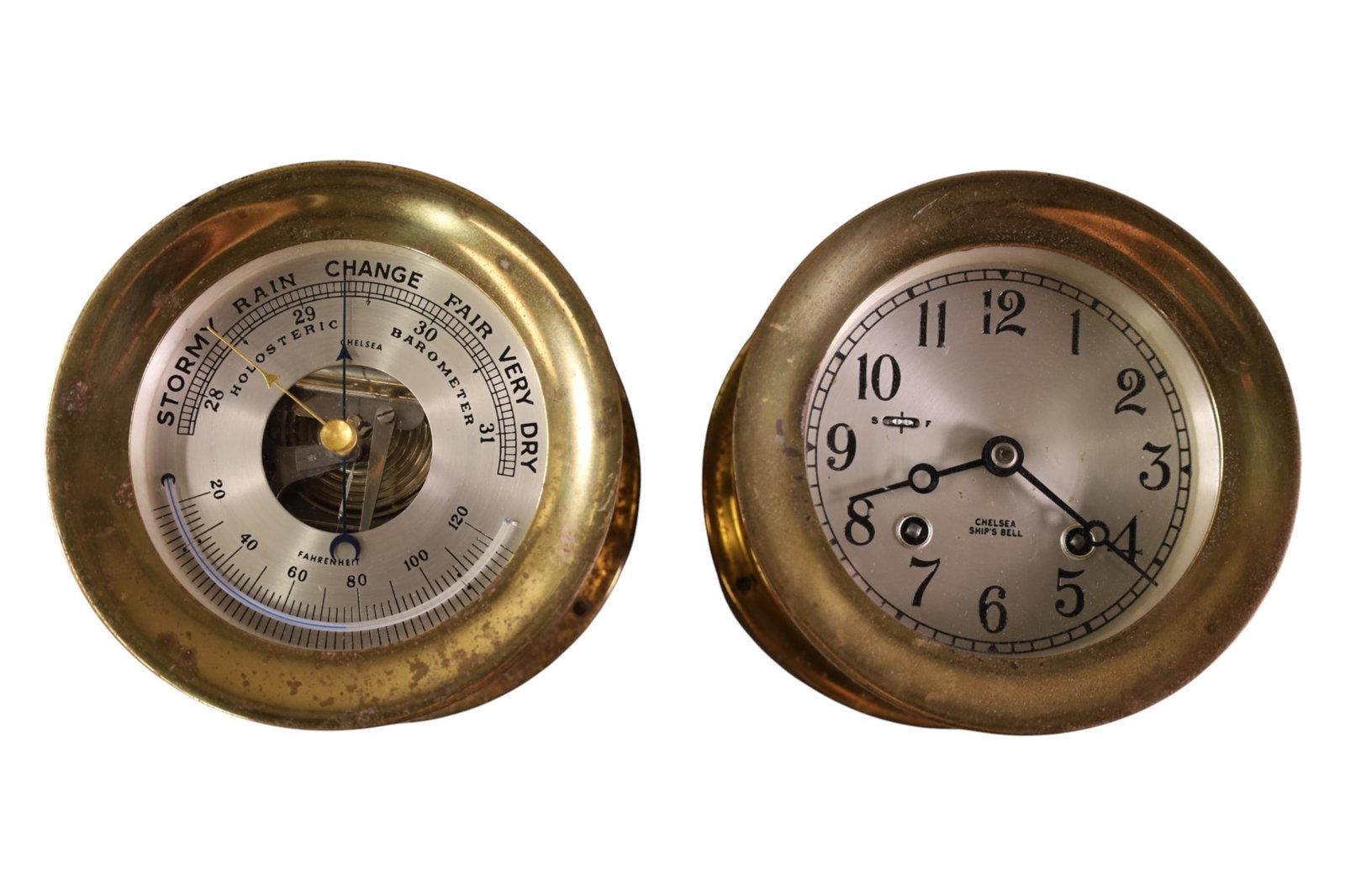 CHELSEA CLOCK & BAROMETER: BRASS CASED SHIPS BELL CLOCK & BRASS CASES HOLOSTERIC BAROMETER. PITTING TO METAL. 5 1/2" H. ALL CLOCKS ARE SOLD AS IS WE DO NOT GUARANTEE WORKNG ORDER