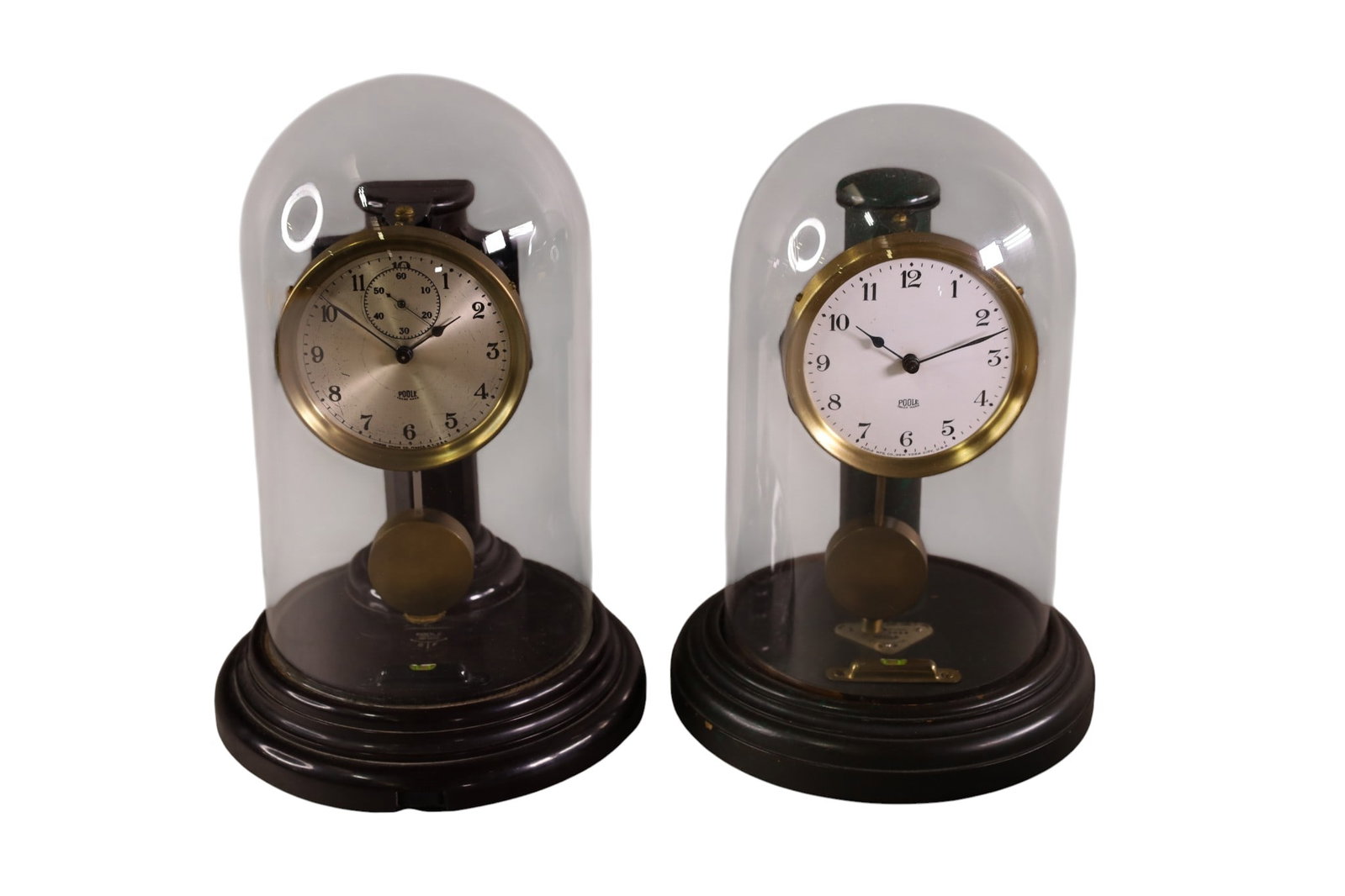 2 POOLE ANNIVERSARY CLOCKS: IN GLASS DOMES, 10" H. 1 TOP IS LOOSE. ALL CLOCKS ARE SOLD AS IS WE DO NOT GUARANTEE WORKING ORDER.