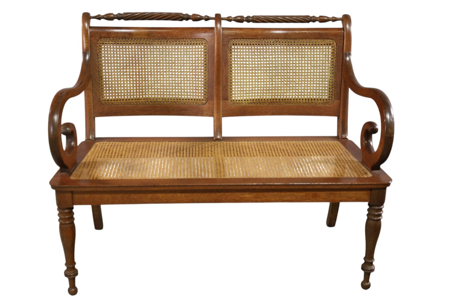 ANTIQUE OAK BENCH: CANE SEAT AND BACK, ORNATE OAK BENCH, 43" W x 25" D x 35" H. THIS ITEM EXCEEDS SIZE, WEIGHT, AND OR FRAGILITY LIMITATIONS FOR IN HOUSE SHIPPING, MUST BE PICKED UP IN HOUSE OR SHIPPED VIA 3RD PARTY SHI