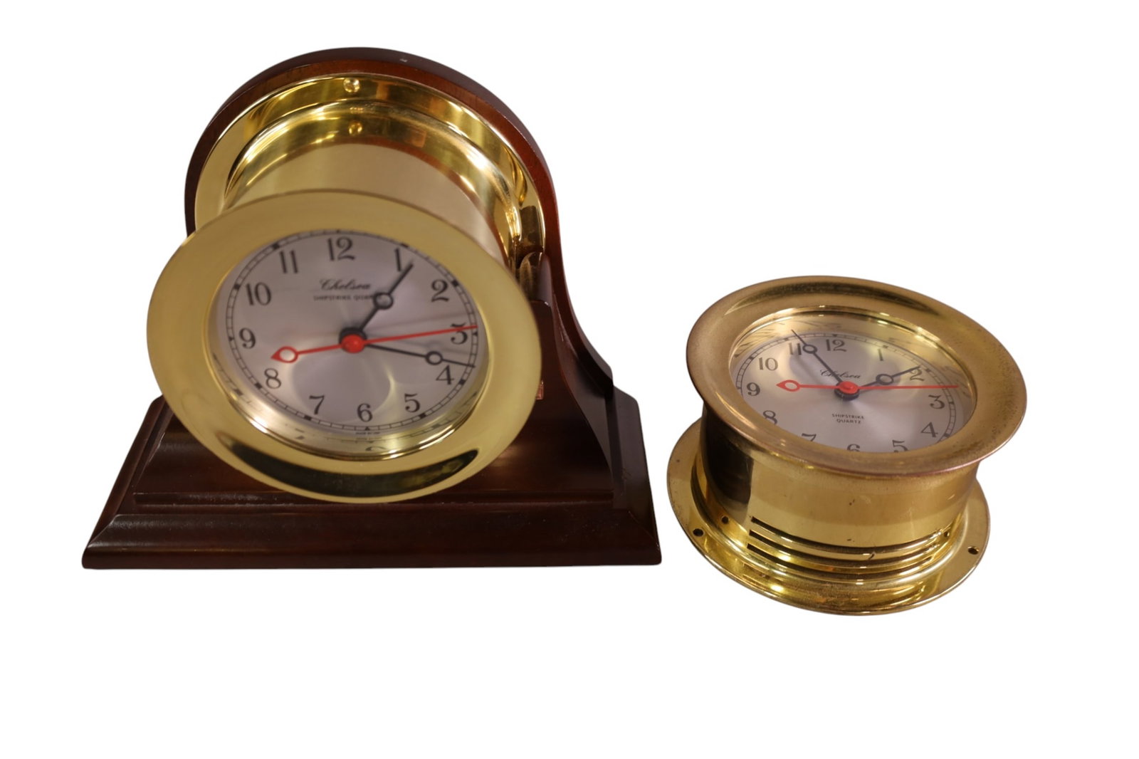 2 SHIPS CLOCKS: 2 CHELSEA SHIPSTRIKE QUARTZ BRASS CLOCKS, ONE IN HOLDER. 5 1/2" DIAM. ALL CLOCKS ARE SOLD AS IS WE DO NOT GUARANTEE WORKING ORDER