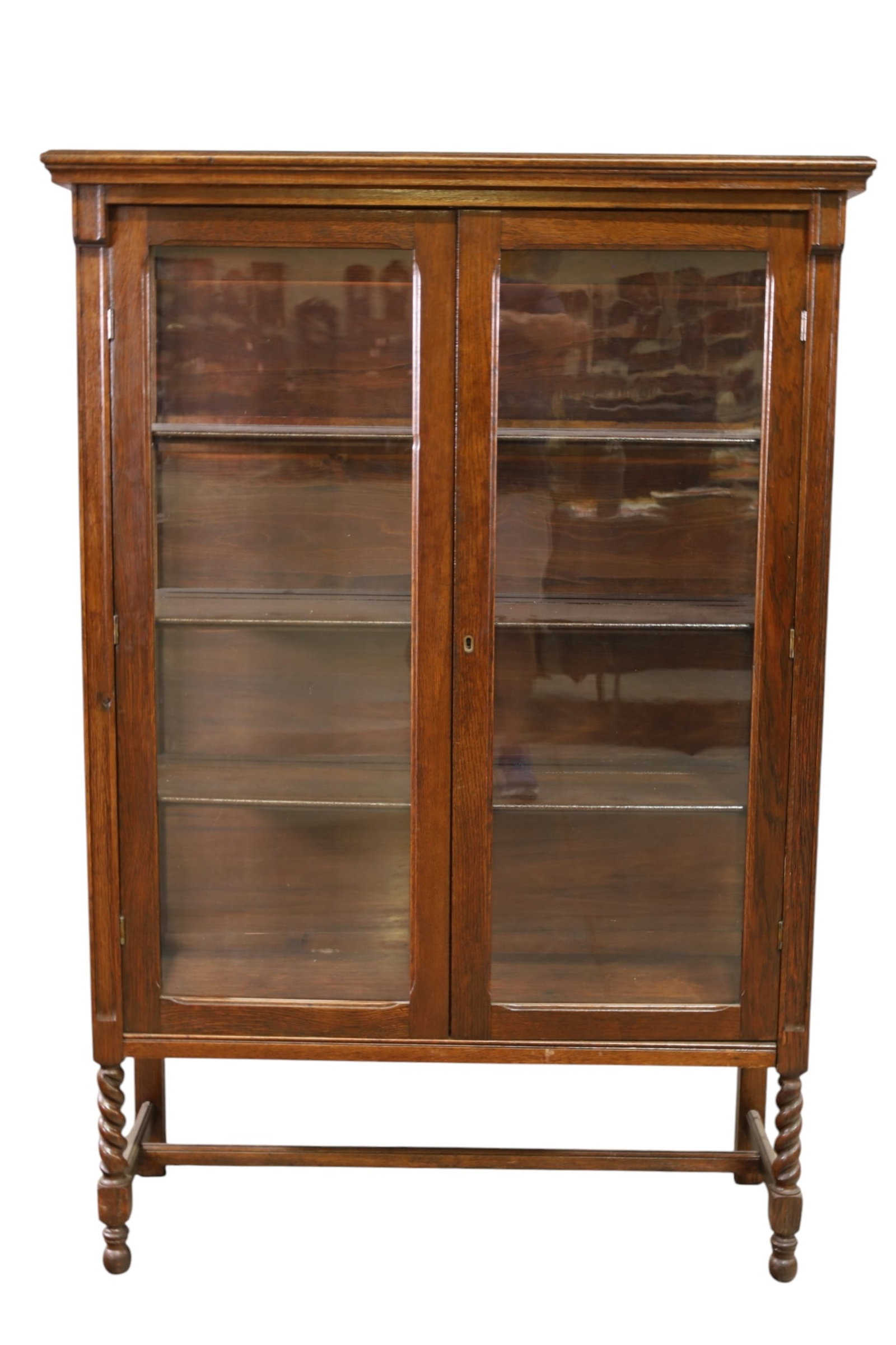 1910'S OAK CHINA CABINET: OAK TWO DOOR CHINA CABINET, INTERIOR WOOD SHELVES. NO KEY. 41" W x 16 1/2" D x 60" H. THIS ITEM EXCEEDS SIZE, WEIGHT, AND OR FRAGILITY LIMITATIONS FOR IN HOUSE SHIPPING, MUST BE PICKED UP IN HOUSE OR
