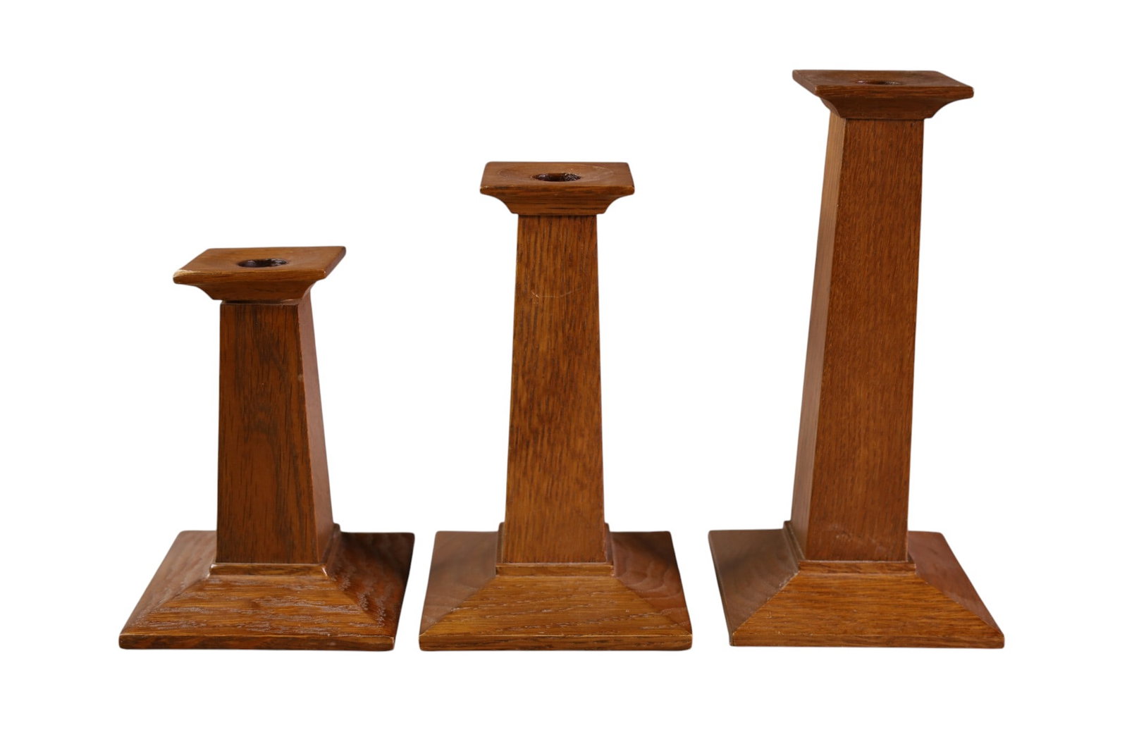 3 STICKLEY CANDLESTICKS: OAK ARTS & CRAFTS CANDLESTICKS, MARKED STICKLEY. 6" - 9" H.