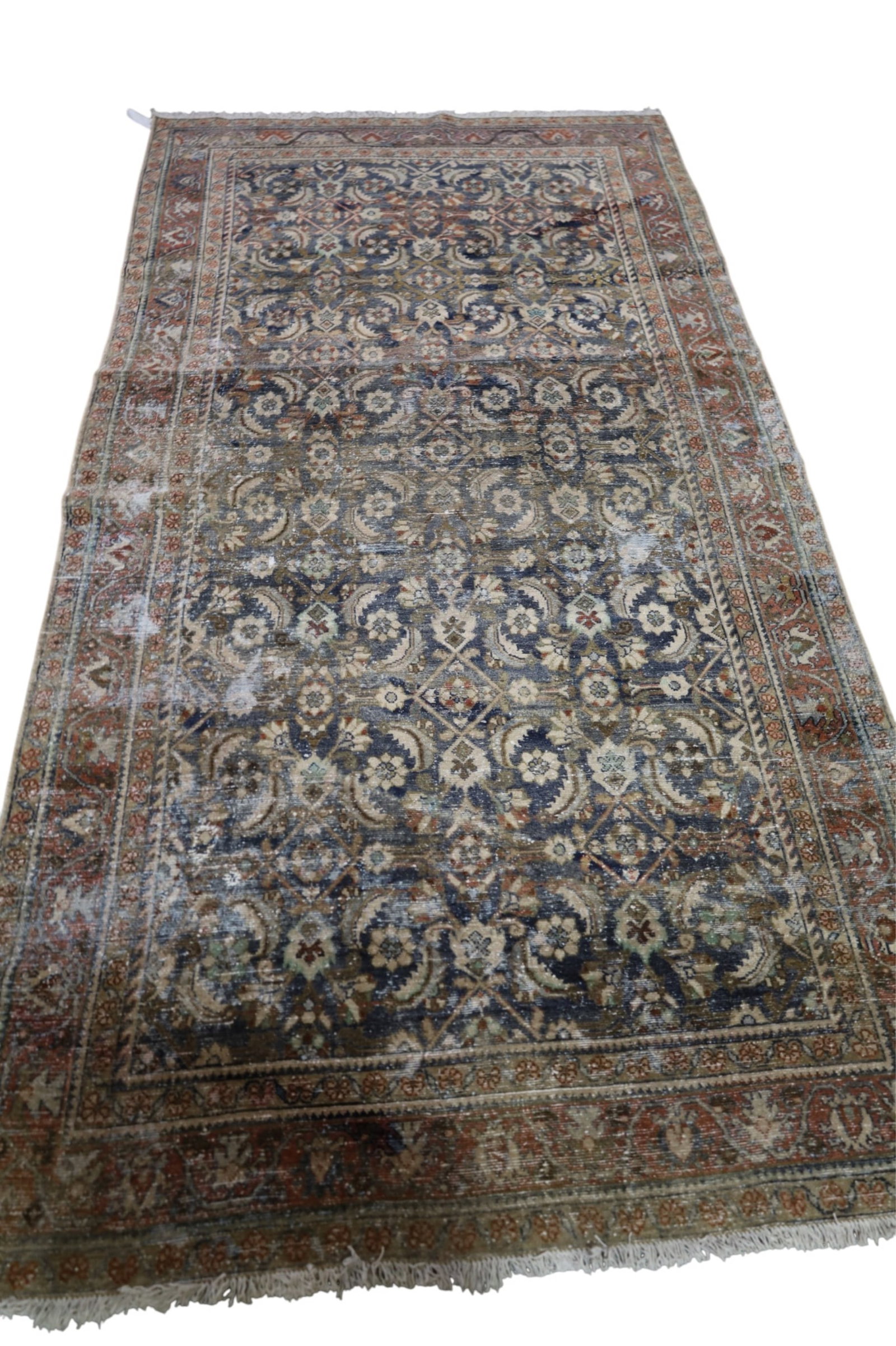 APPROX 5' 5" x 9' 9" HANDMADE WOOL RUG: MOTH DAMAGE.