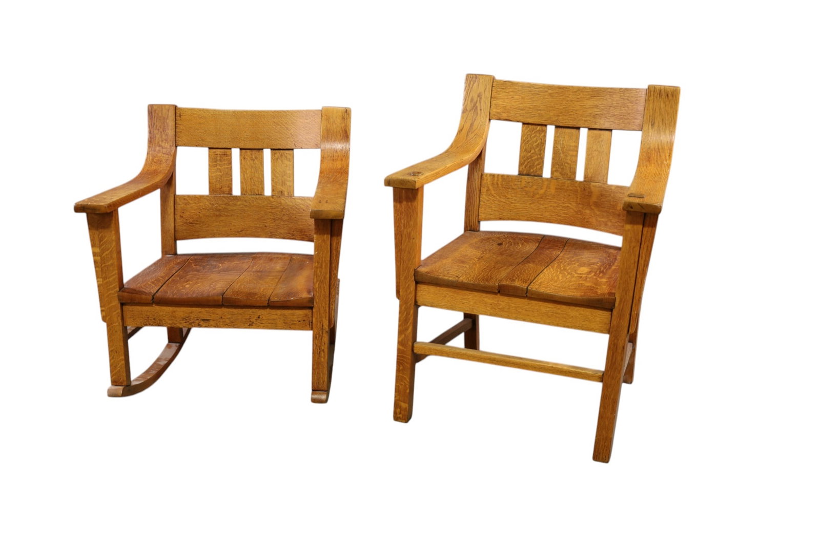 PAIR OF ARTS & CRAFTS OAK CHAIRS: HIS AND HERS OAK ARTS & CRAFTS CHAIRS, ARMCHAIR AND ROCKER. WEAR TO FINISH. LOOSE AT JOINTS. 27" W x 23" D x 35" H. & 27" W x 23" D x 30" H. THIS ITEM EXCEEDS SIZE, WEIGHT, AND OR FRAGILITY