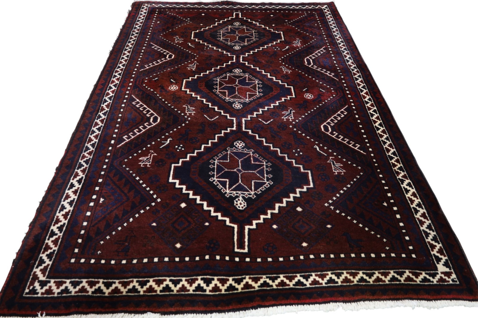 APPROX 8' 6" x 5' 7" HANDMADE WOOL RUG: HANDMADE WOOL RUG, EDGE WEAR.