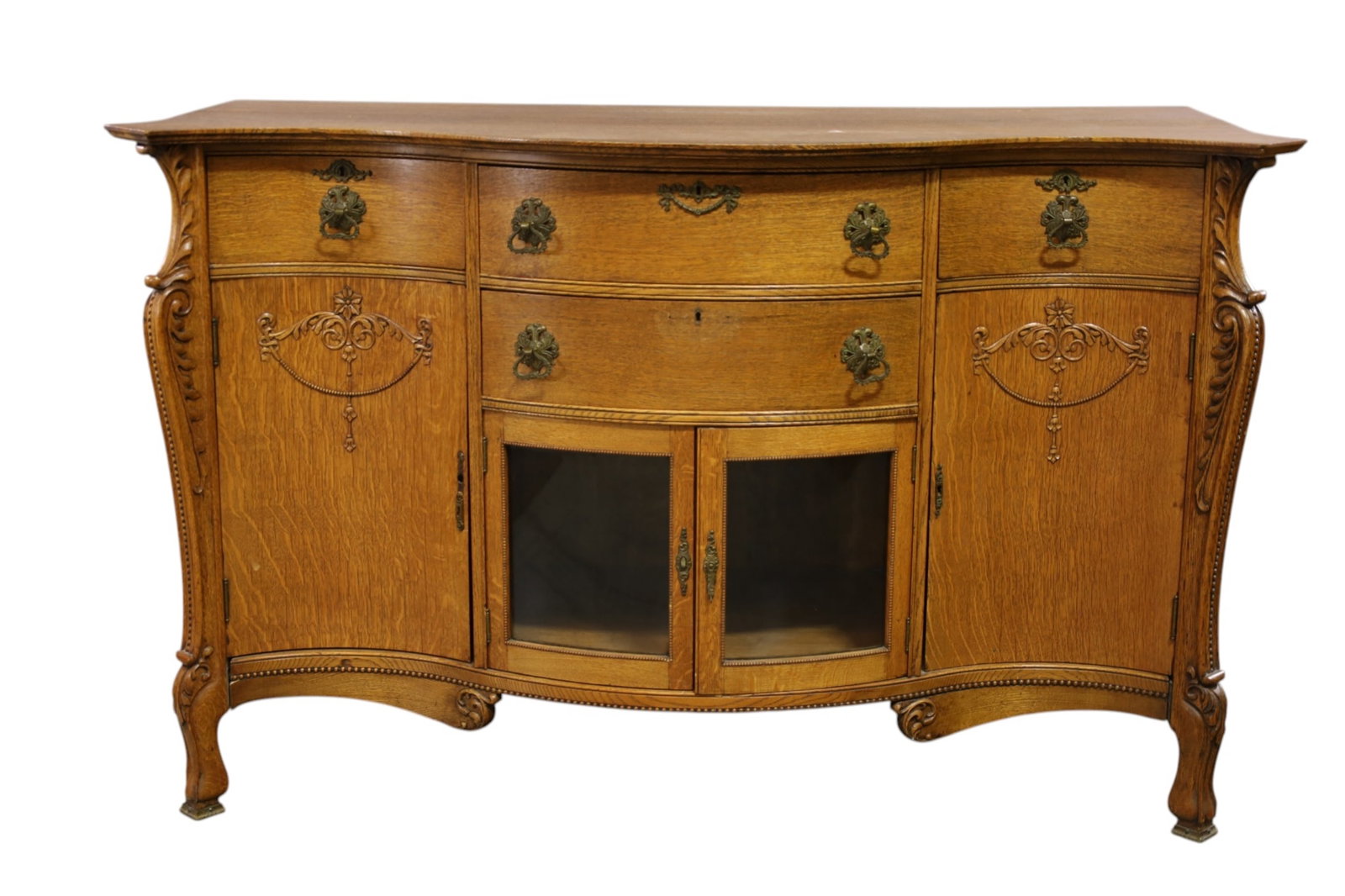 1900'S AM. OAK BUFFET: AMERICAN OAK BUFFET, CURVED GLASS LOWER DOORS, MINOR WEAR TO FINISH. 64" W x 24" D x 40" H. THIS ITEM EXCEEDS SIZE, WEIGHT, AND OR FRAGILITY LIMITATIONS FOR IN HOUSE SHIPPING, MUST BE PICKED UP IN HOU