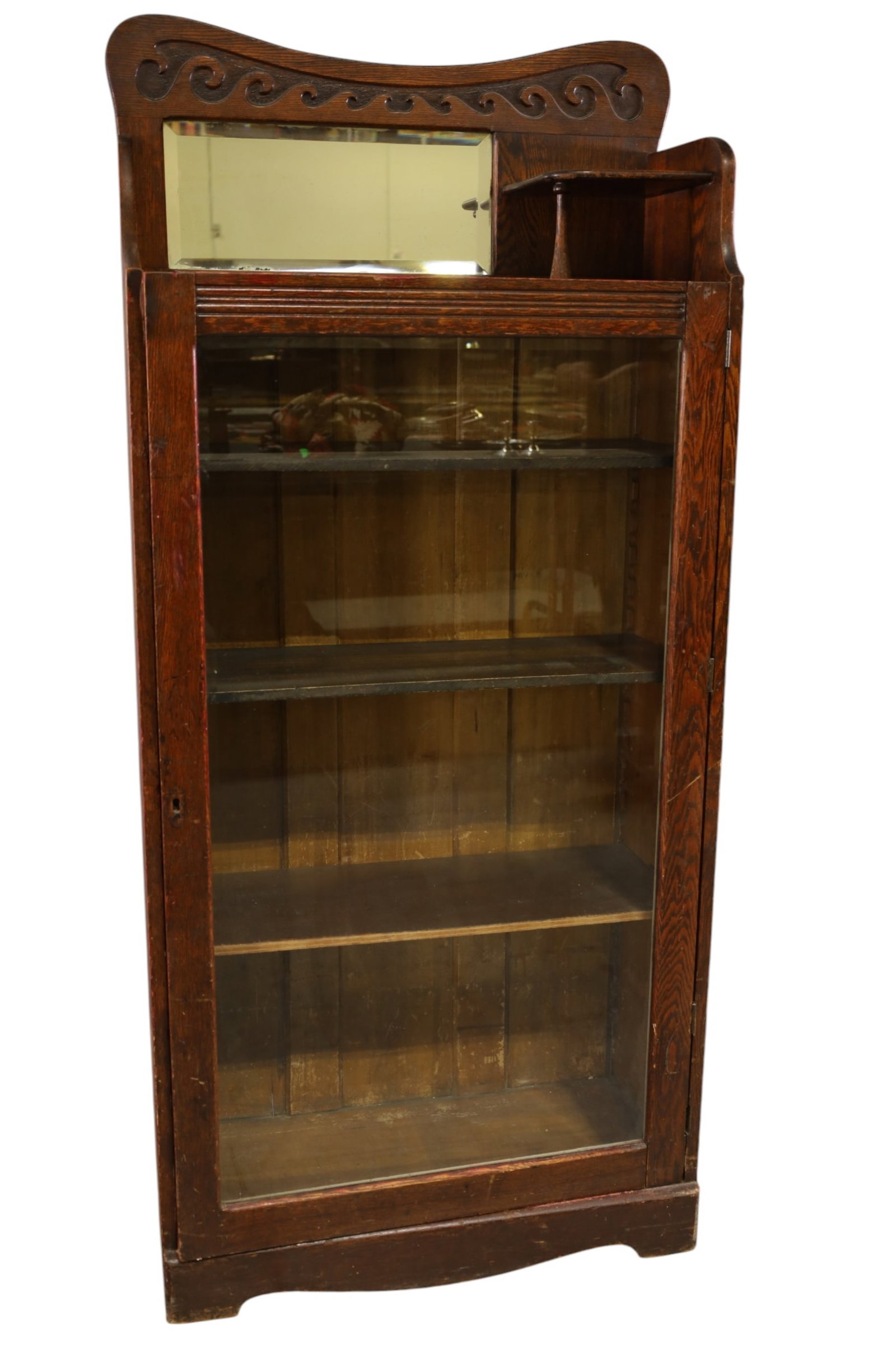 1900'S AM. OAK BOOKCASE: SINGLE DOOR AMERICAN OAK BOOKCASE, MIRORRED BACK. FINISH LOSS, REPLACED SHELVES. 30" W x 15" x 66" H. THIS ITEM EXCEEDS SIZE, WEIGHT, AND OR FRAGILITY LIMITATIONS FOR IN HOUSE SHIPPING, MUST BE PICKED