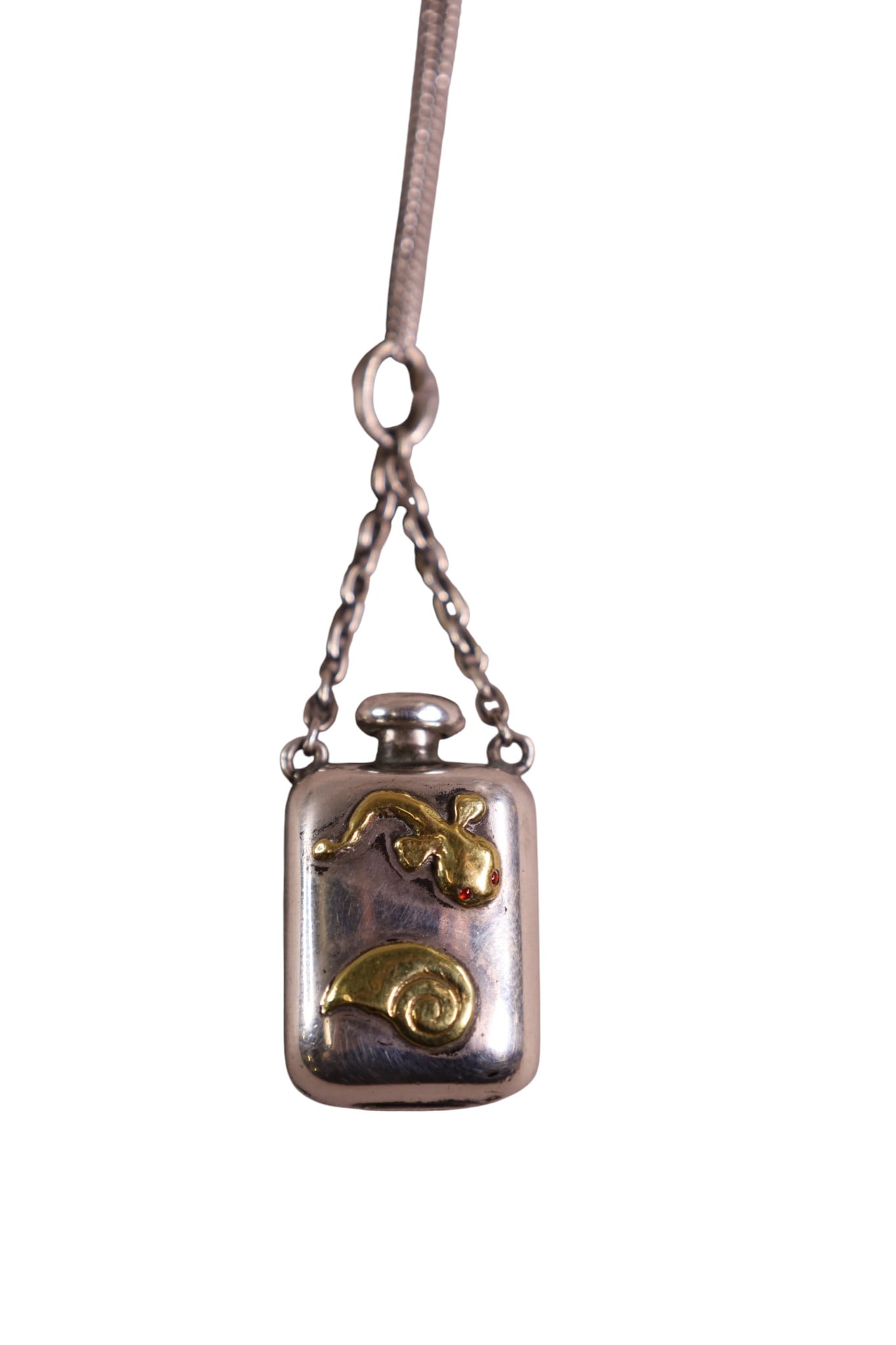 SMALL PERFUME PENDANT: MIXED METAL PERFUME PENDANT, STERLING WITH GOLD FISH AND SNAIL DECORATION. ON CHAIN