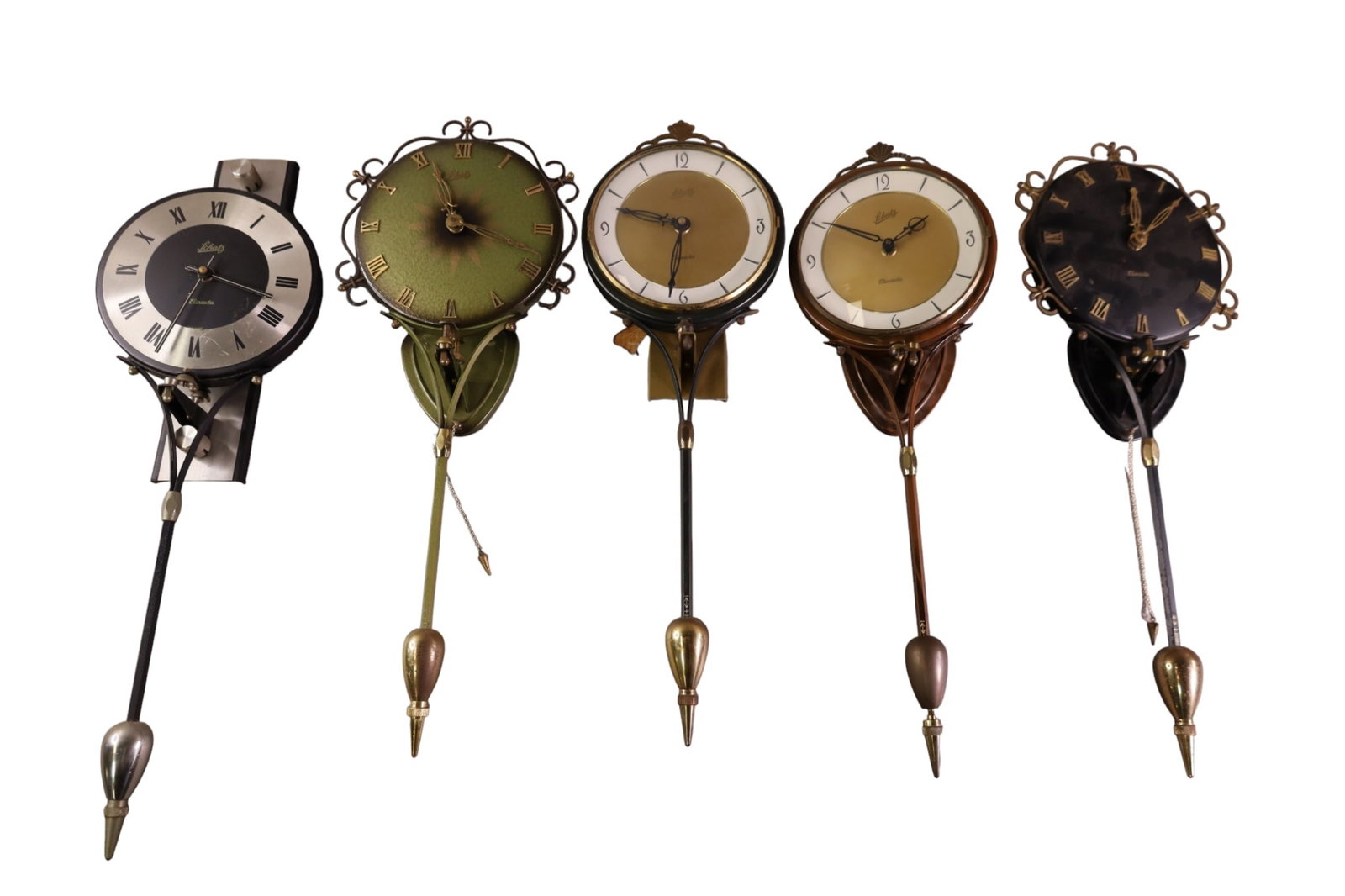 5 SCHATZ WALL CLOCKS: ELEXACTA, SCHATZ WALL CLOCKS, 20" - 24" H. ALL CLOCKS ARE SOLD AS IS WE DO NOT GUARANTEE WORKING ORDER. THIS ITEM EXCEEDS SIZE, WEIGHT, AND OR FRAGILITY LIMITATIONS FOR IN HOUSE SHIPPING, MUST BE PICK