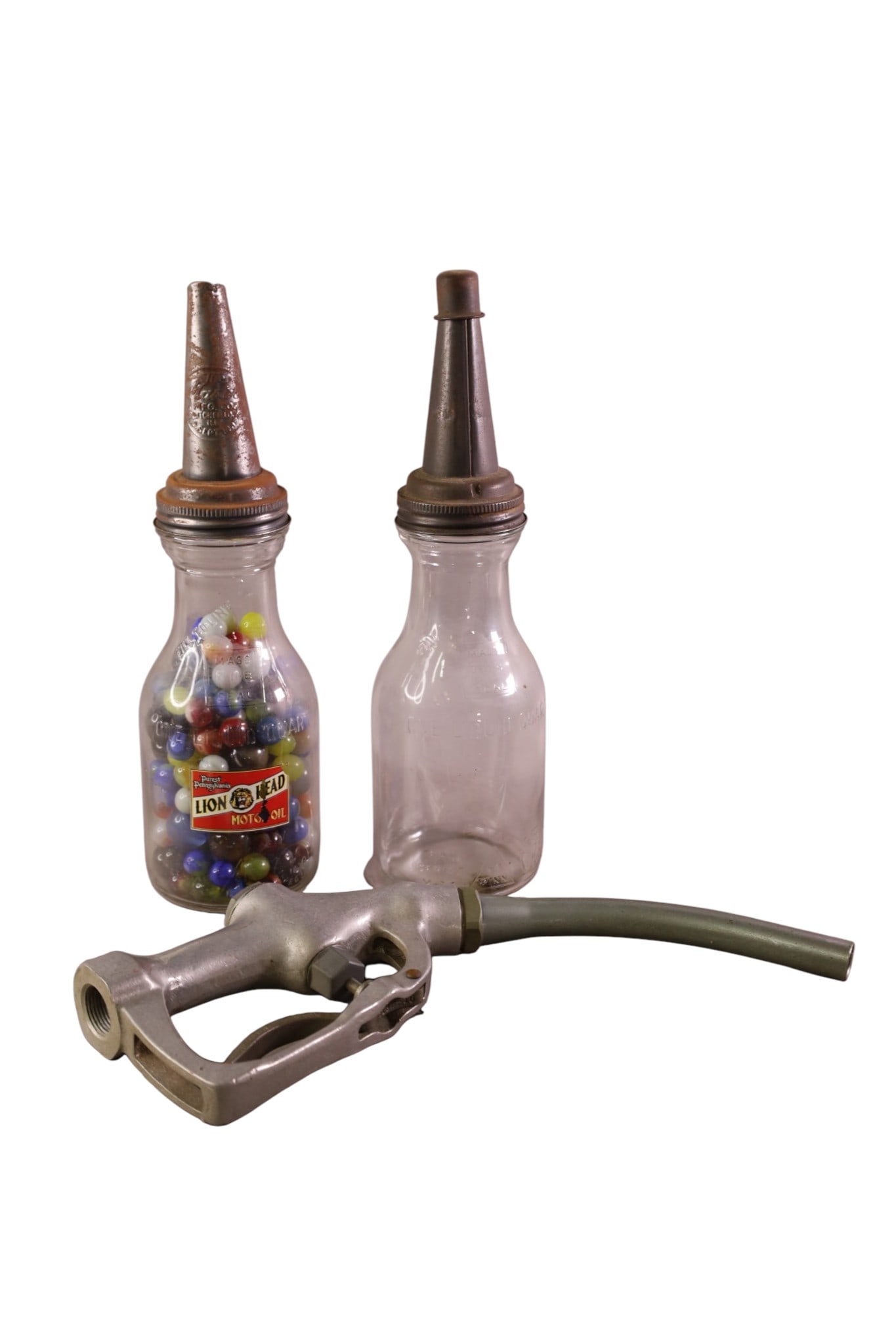 2 GAS ITEMS: BUCKEYE NOZZLE & OIL BOTTLE WITH MARBLES.