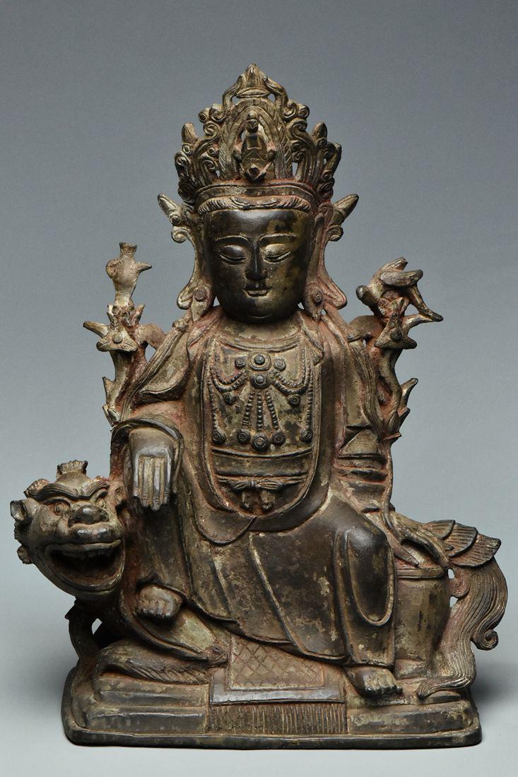 A MING BRONZE FIGURE OF GUANYIN SEATED ON A LION (1 of 18)