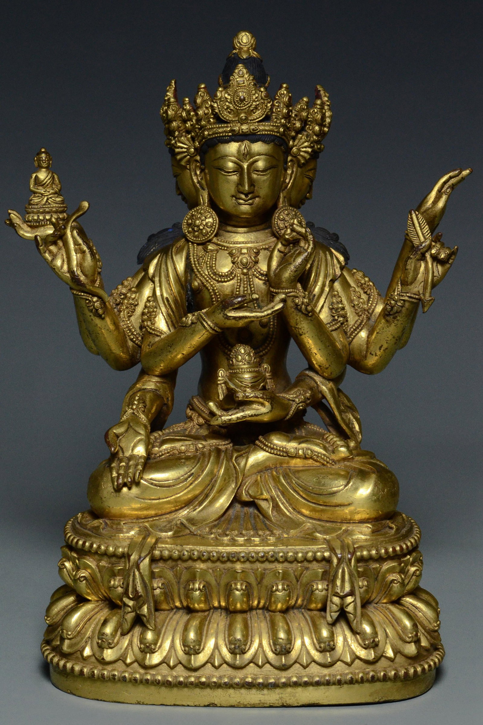GILT BRONZE USHNISHAVIJAYA YONGLE MARK & PERIOD: A MING DYNASTY GILT BRONZE FIGURE OF USHNISHAVIJAYA YONGLE MARK AND PERIOD. Dimensions: 8 3/4 x 6 1/2 x 4 1/2 in. Provenance: The vendors relative was one Mr Robin George who was trained as a lawyer i