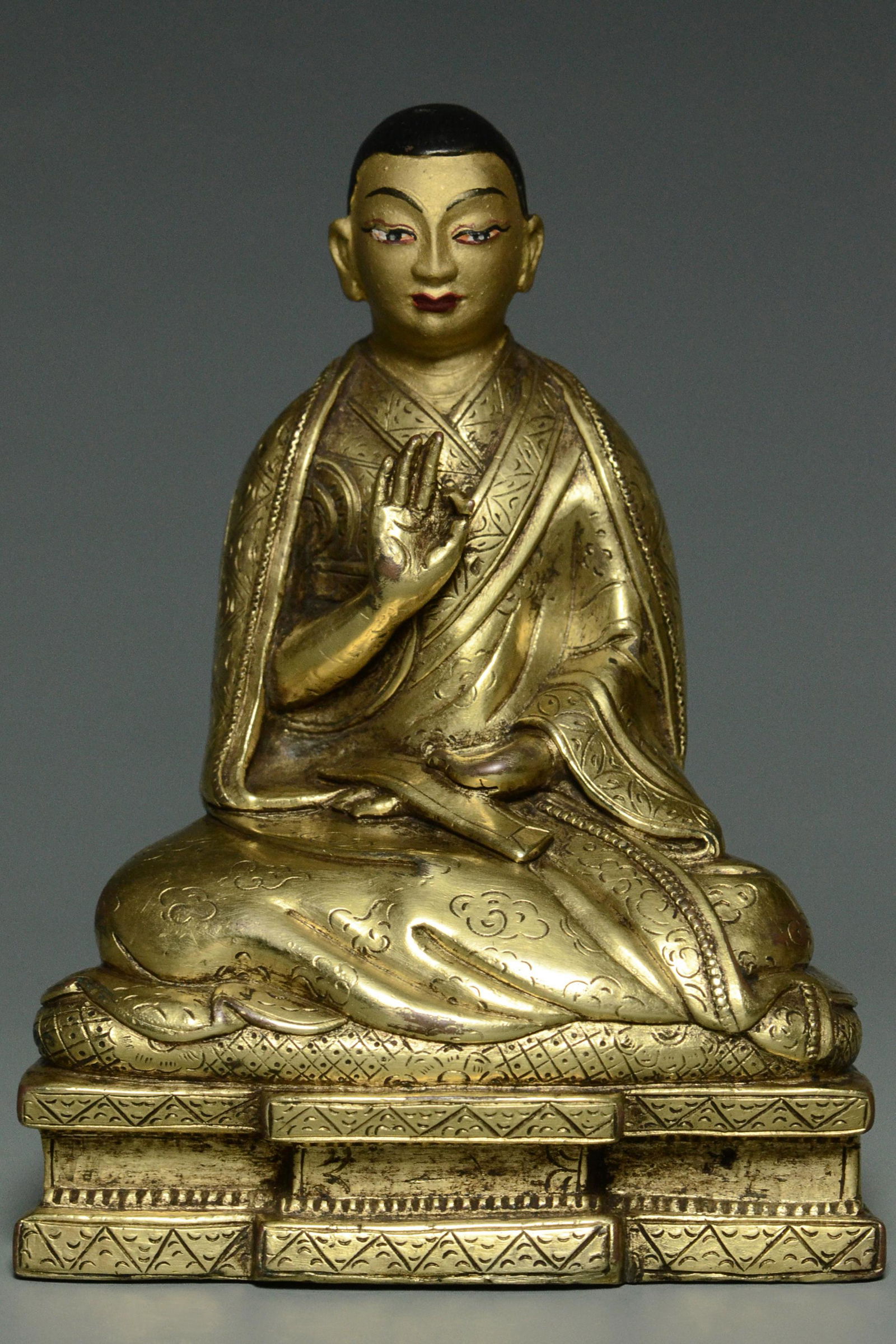 AN INSCRIBED QING GILT BRONZE FIGURE OF A LAMA (1 of 15)