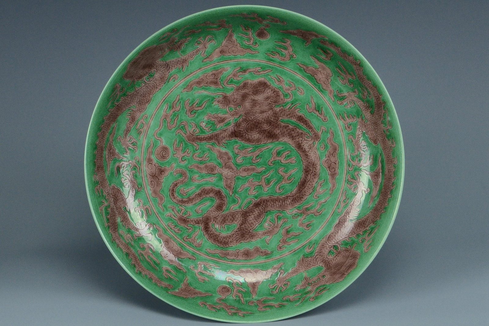 A DRAGON DISH KANGXI MARK AND PERIOD: A DRAGON DISH KANGXI MARK AND PERIOD. Dimensions: 10 1/2 x 2 1/4 in. Provenance: Formerly in the collection of the Marshall Coyne, noted Washington, D.C. Hotelier, friend of statesmen, etc.. He travel