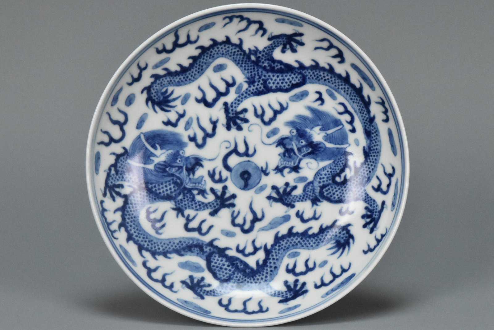 A BLUE AND WHITE DRAGON DISH QIANLONG MARK: A BLUE AND WHITE DRAGON DISH QIANLONG MARK. Dimensions: 5 1/2 x 1 1/4 in. High resolution pictures can be found at https://file.ac/63IGR32wtJA/