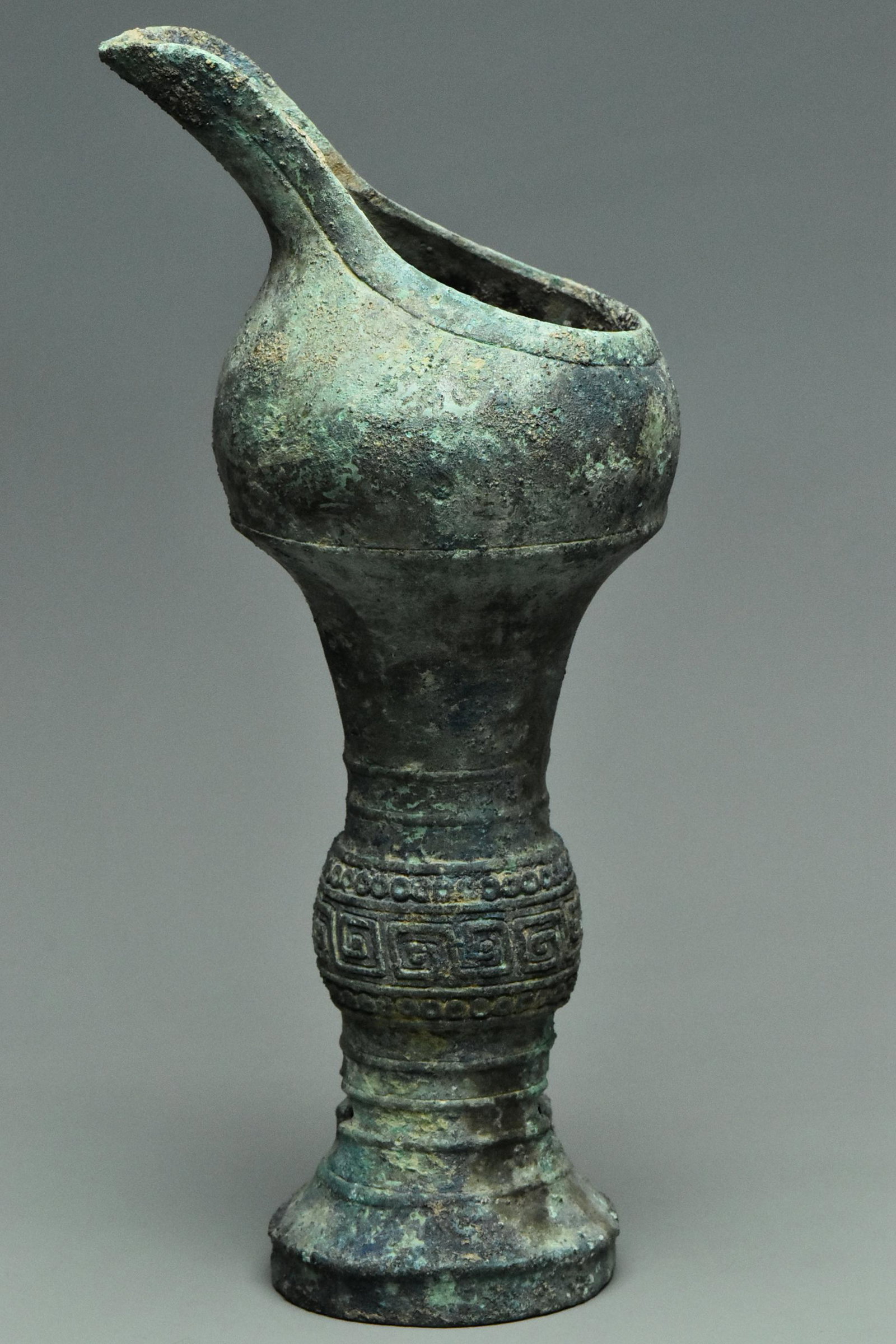 A SHANG DYNASTY BRONZE RITUAL WINE VESSEL GU: AN EARLY SHANG DYNASTY BRONZE RITUAL WINE VESSEL GU WITH CHARACTER INSCRIPTION. Dimensions: 8 x 3 3/4 x 3 in. Provenance: Samuel E. Wilson(1891-1965), thence by descent. Acquired whilst living in Chin