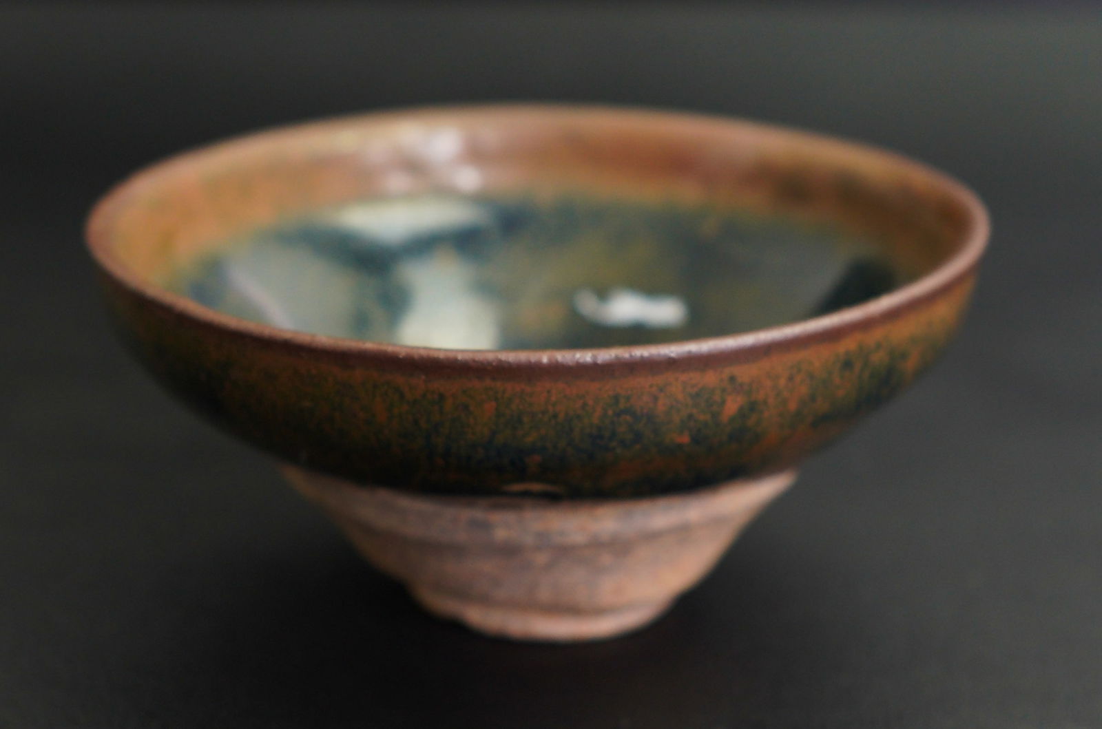 CHINESE JIAN 'HARE'S FUR' TEA BOWL, Song Dynasty: Size: 4" x 4" x 2". Description: Decorated with a lustrous thick black glaze streaked with brown inclusions that falls unevenly around the foot. Tri-State area in house truck delivery available. In ho