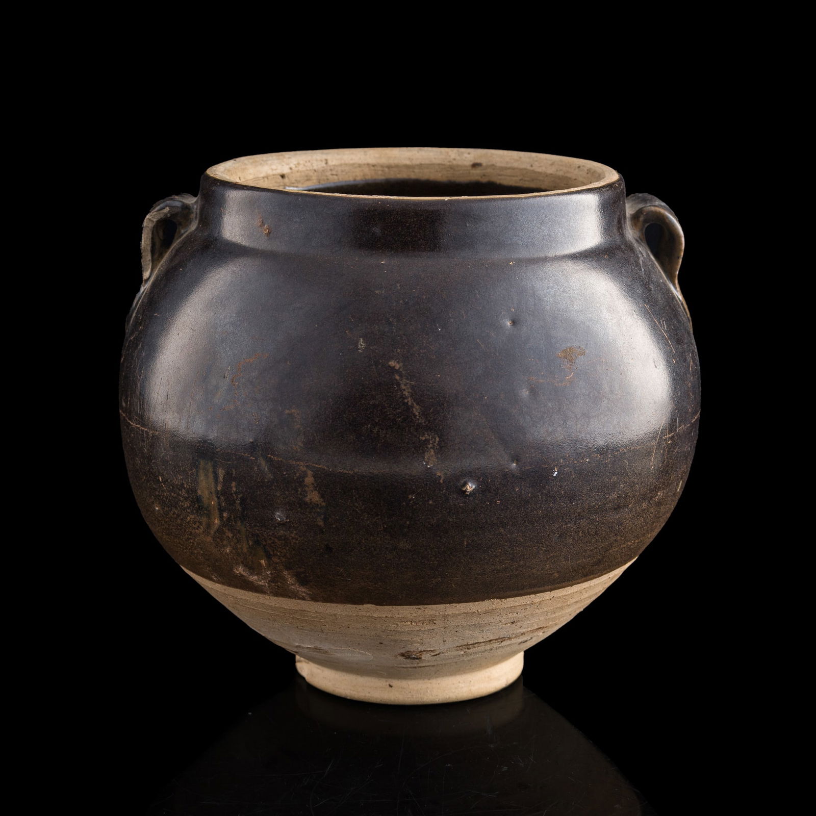 A Chinese black-glazed double-handled jar, Ming dynasty or earlier (1 of 2)