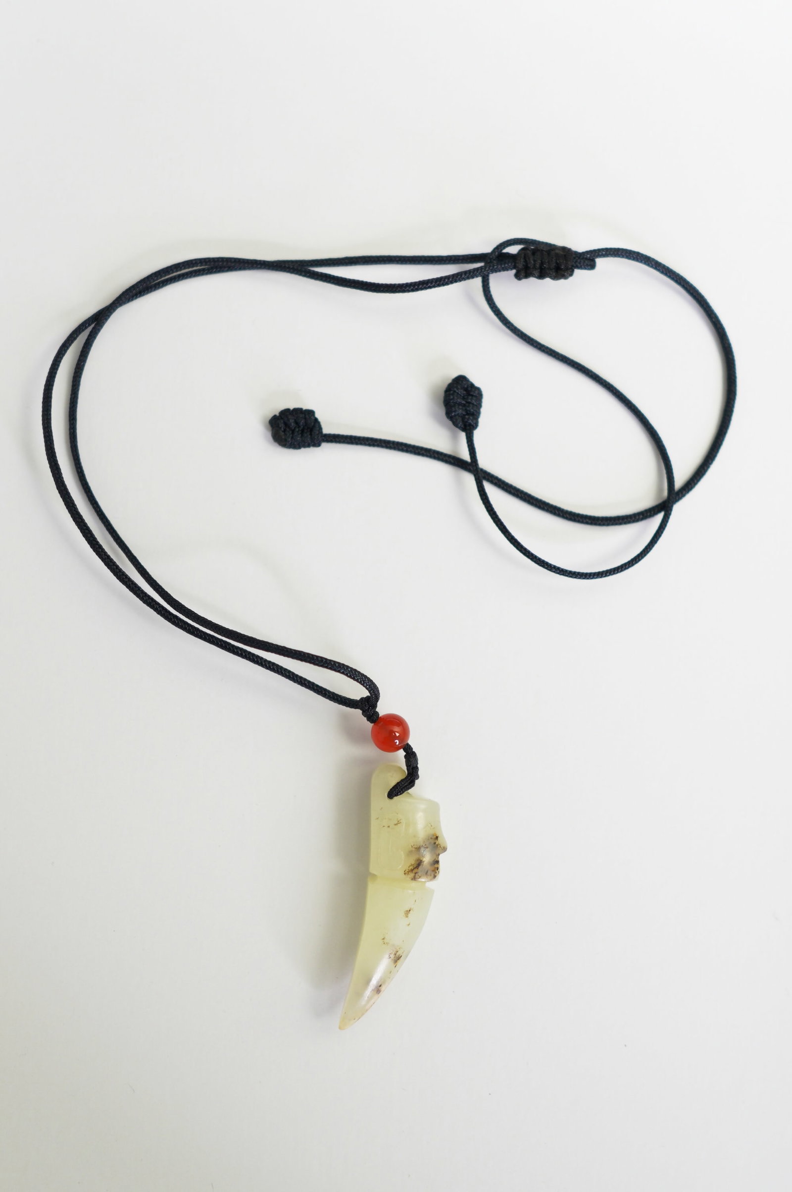 A CHINESE WHITE JADE CARVED HUMAN FACED PENDANT, QING DYNASTY (1644 - 1911) (1 of 7)