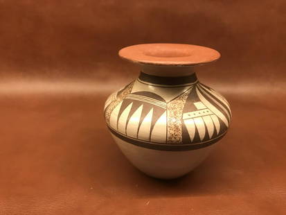 Hisi Quotskuyva Nampeyo, b. 1964: Tan-glazed vase with red lip and geometric Hopi patterns painted in brown around shoulder. Signed "Hisi Nampeyo" on base next to an ear of corn Condition very good; few small losses of paint. 3.75"H x