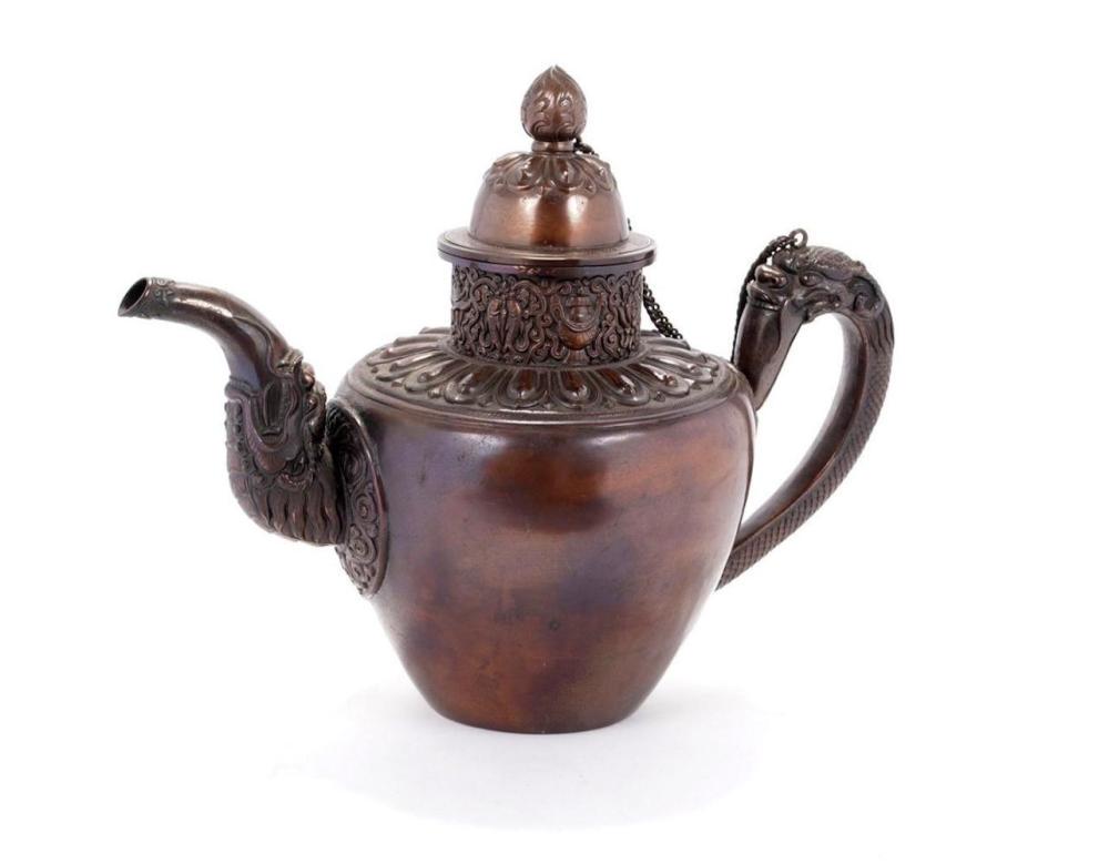 Ceremonial Copper Tea Kettle, Tibet, 19th Century: Heavy ceremonial copper teapot on domed circular foot chased with scroll-work, the compressed hammered globular body with raised neck fitted with a band of scroll-work, the handle with a gui-dragon, t