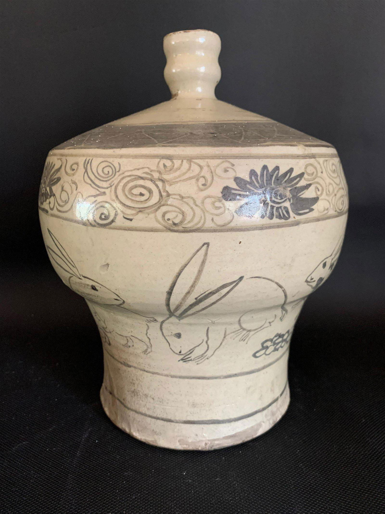 Early Edo Period Rabbit Sake Bottle: This Japanese Edo Period (1603-1868) Sake Bottle is decorated with multiple underglaze rabbits at play. First half 18th century. 8.5 inches tall.