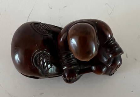 Fruitwood Netsuke of Man with Oni, Meiji Period: Meiji Period netsuke of man with oni at Setsubun festival. Dimensions: 2" x 3/4" x 1/2".
