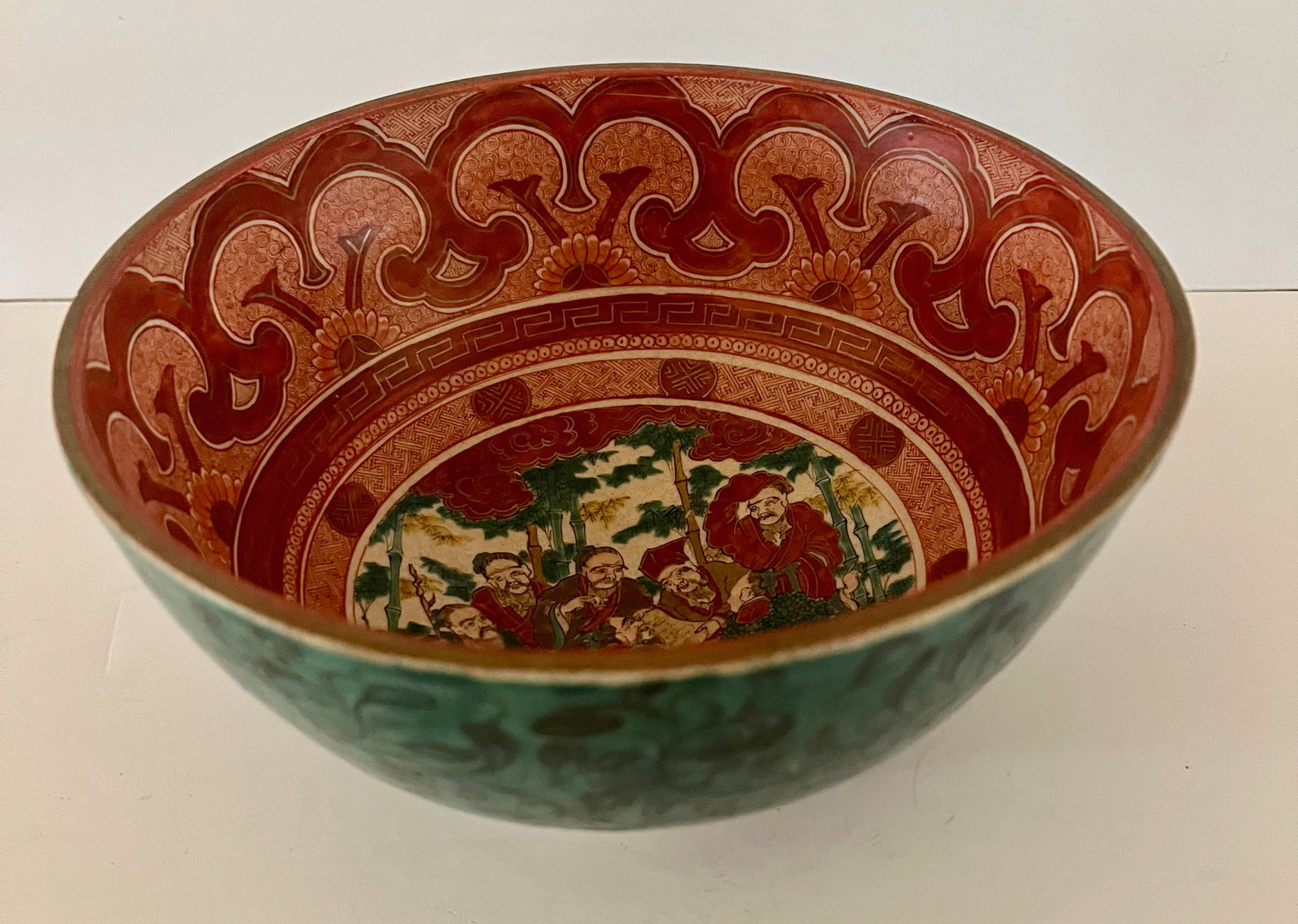 Large Ao-Kutani Bowl, Yoshidaya Kiln, Edo Period, Early 19th Century: Superb and large Ao-Kutani bowl in typical Yoshidaya enameling with exterior glazed in green and the interior in Kinrande red with central motif of the Lucky Gods in a bamboo grove. Early 19th Century