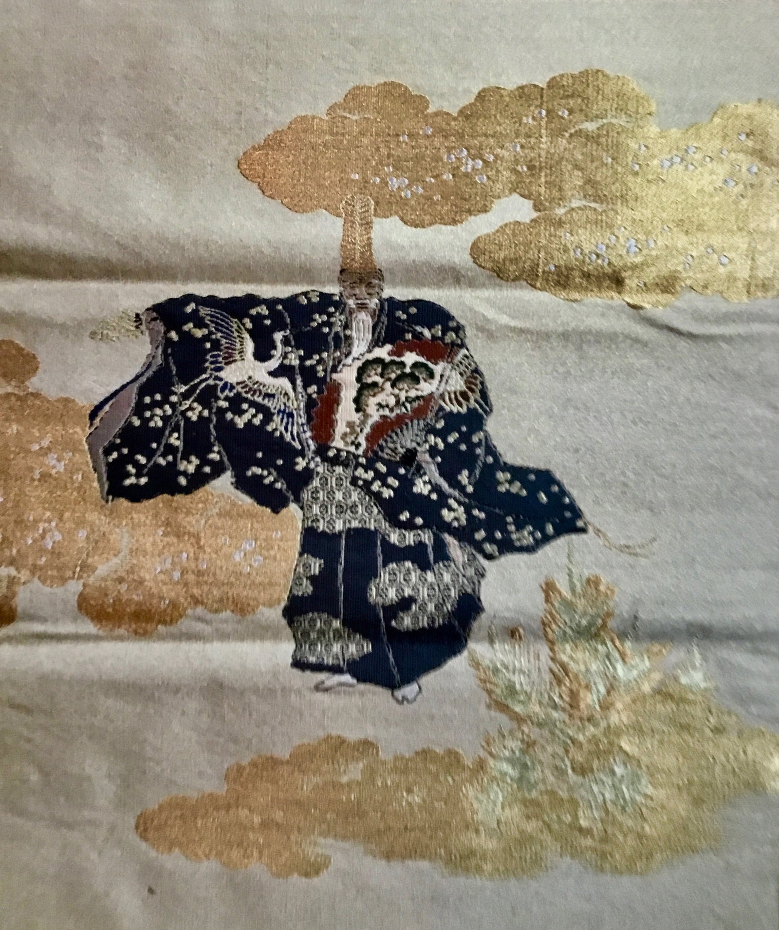 Embroidered Okina Dancer Fukusa, Edo Period: This ornately embroidered Fukusa features an Okina Bugaku dancer on a background.of woven gold threads. Various different gold threads are used to create multiple shades of gold. Middle 19th century.