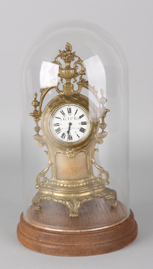 Antique English brass table clock under bell jar with pocket watch movement. Joh: Antique English brass table clock under bell jar with pocket watch movement. John Walker London. Two windings. Size: 30 x 16 cm ø. In good condition.