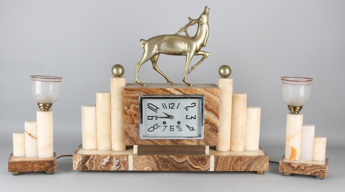Large French onyx with marble Art Deco clock set with: Large French onyx with marble Art Deco clock set with deer. Circa 1930. Chip. Eight-day movement, half-hour stroke and spring garland. Size: 73 x 51 x 12 cm. In reasonable / good condition.
