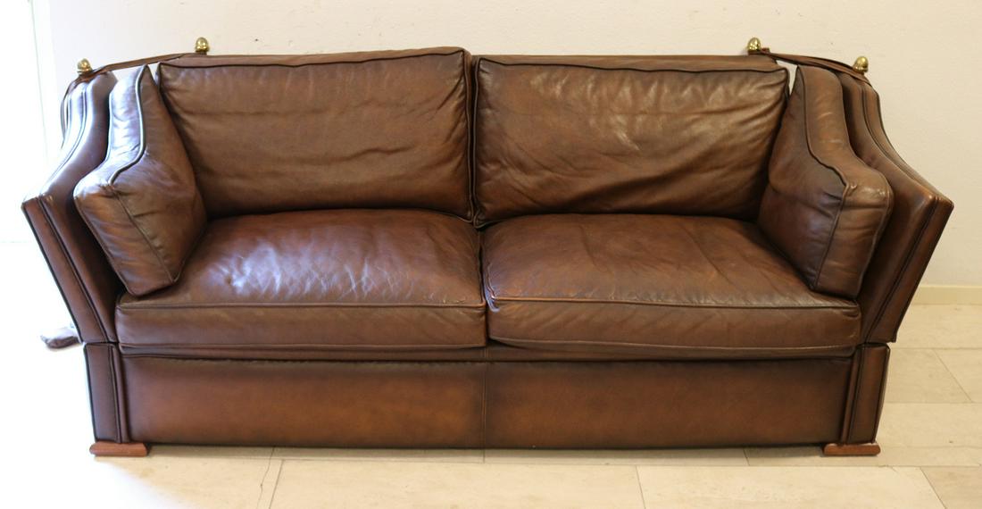 Brown leather sofa, also called castle sofa. With: Brown leather sofa, also called castle sofa. With folding sides, corners with brass buttons. Dimensions: W 200 x H 80 x D 90 cm. In very good condition.