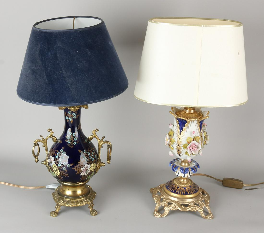 Two old / antique porcelain table lamps with brass.: Two old / antique porcelain table lamps with brass. Hand painted, floral. One time there Sevres flower off. Size: H 46 - H 47 cm. In fair / good condition.