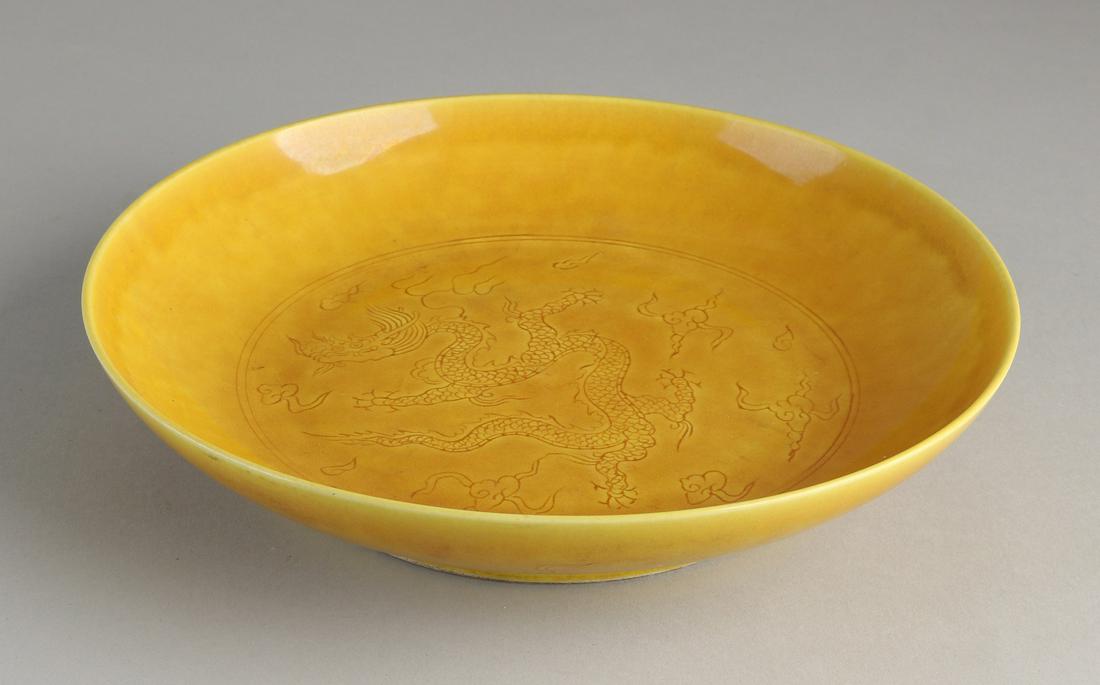 Chinese porcelain dragon plate with ocher yellow glaze (1 of 3)