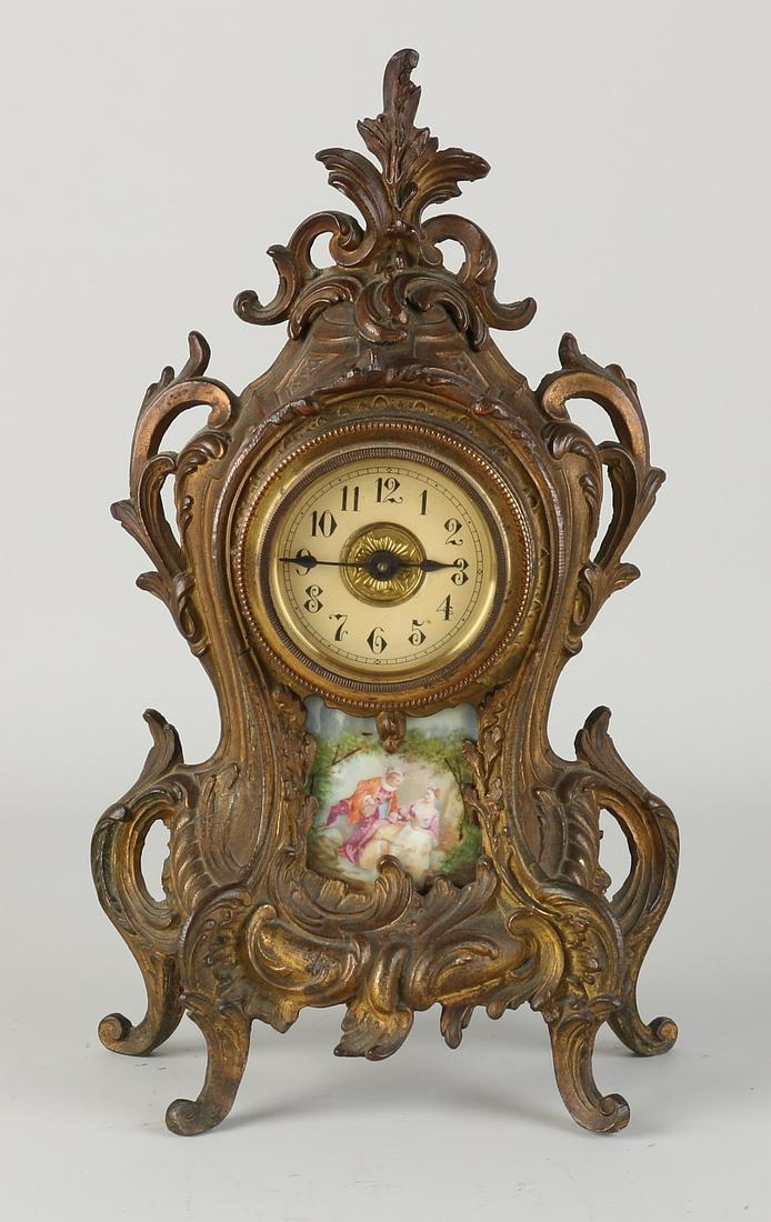 Antique French clock with Limoges plaque: Antique French composition metal table clock with Limoges porcelain plaque. Circa 1900. Size: 29 cm. In good condition.