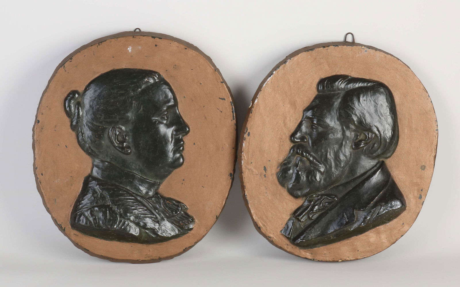 Two antique wall plaques: Two antique Dutch terracotta wall plaques with portraits. One signed C. van Dongen 1901. Chips rim. Dimensions: 28 x 29 cm. In decent shape.