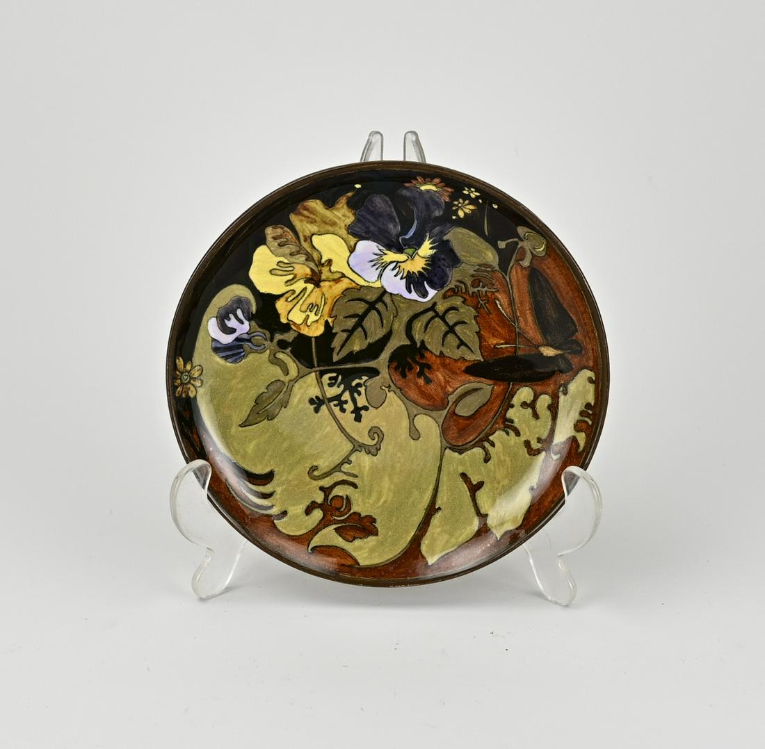 Rozenburg wall dish Ã˜ 17.2 cm.: Antique Rozenburg The Hague earthenware polychrome wall dish with floral decor. Circa 1900. Chip bottom edge. Size: Ã˜ 17.2 cm. In good condition.