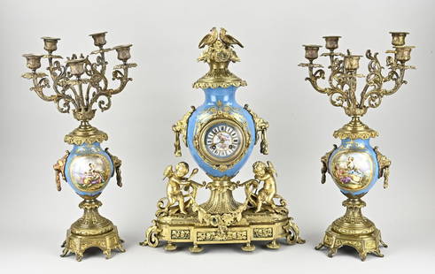 3-piece French clock set, 1860: Antique three-piece gilt bronze + porcelain clock set with putti + candlesticks + Sevres porcelain. France. Circa 1860. Eight-day movement, half-hourly striking, spring pendulum. Size: 50 - 53 cm. In