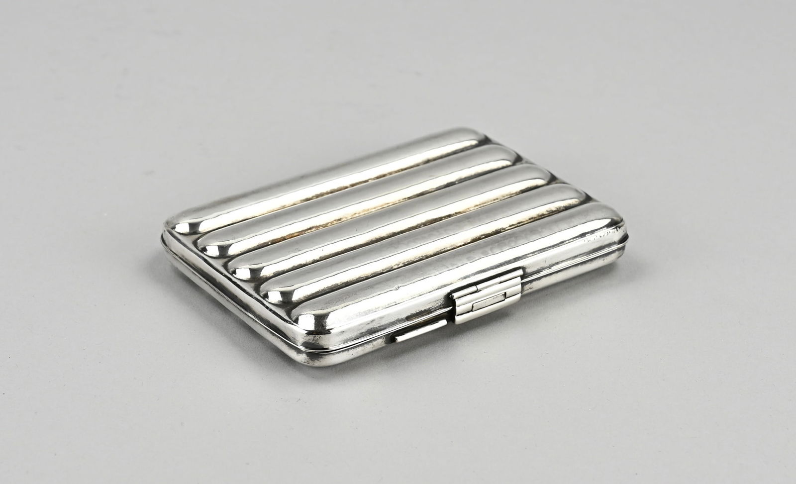 Silver cigar case: Silver cigar case, 835/000, rectangular model with lobed decoration. The box has a hammered decor. MT.: Lutz & Weiss, Pforzheim. approximately 150 grams. 9x12.5x2.5cm. In good condition.
