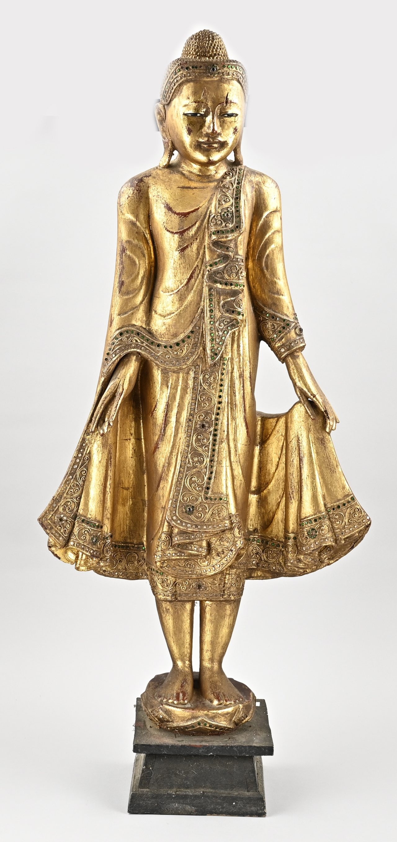 Standing Buddha, approx. H 100 cm.: Old Tibetan gilded Buddha figure of wood, with glass inlay. 20th century. Dimensions: H 102 cm. In good condition.