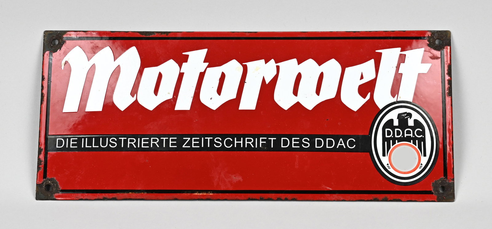 Third Reich billboard: Antique German Third Reich advertising sign made of enamel. Motorwelt Zeitschrift des DPAC. Circa 1935 - 1940. Dimensions: H 17 x W 40 cm. In good condition.